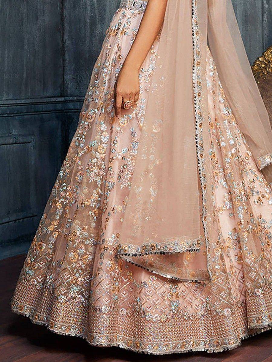 Elegant blush pink lehenga choli with intricate floral embroidery and sequin detailing, perfect for Indian weddings.