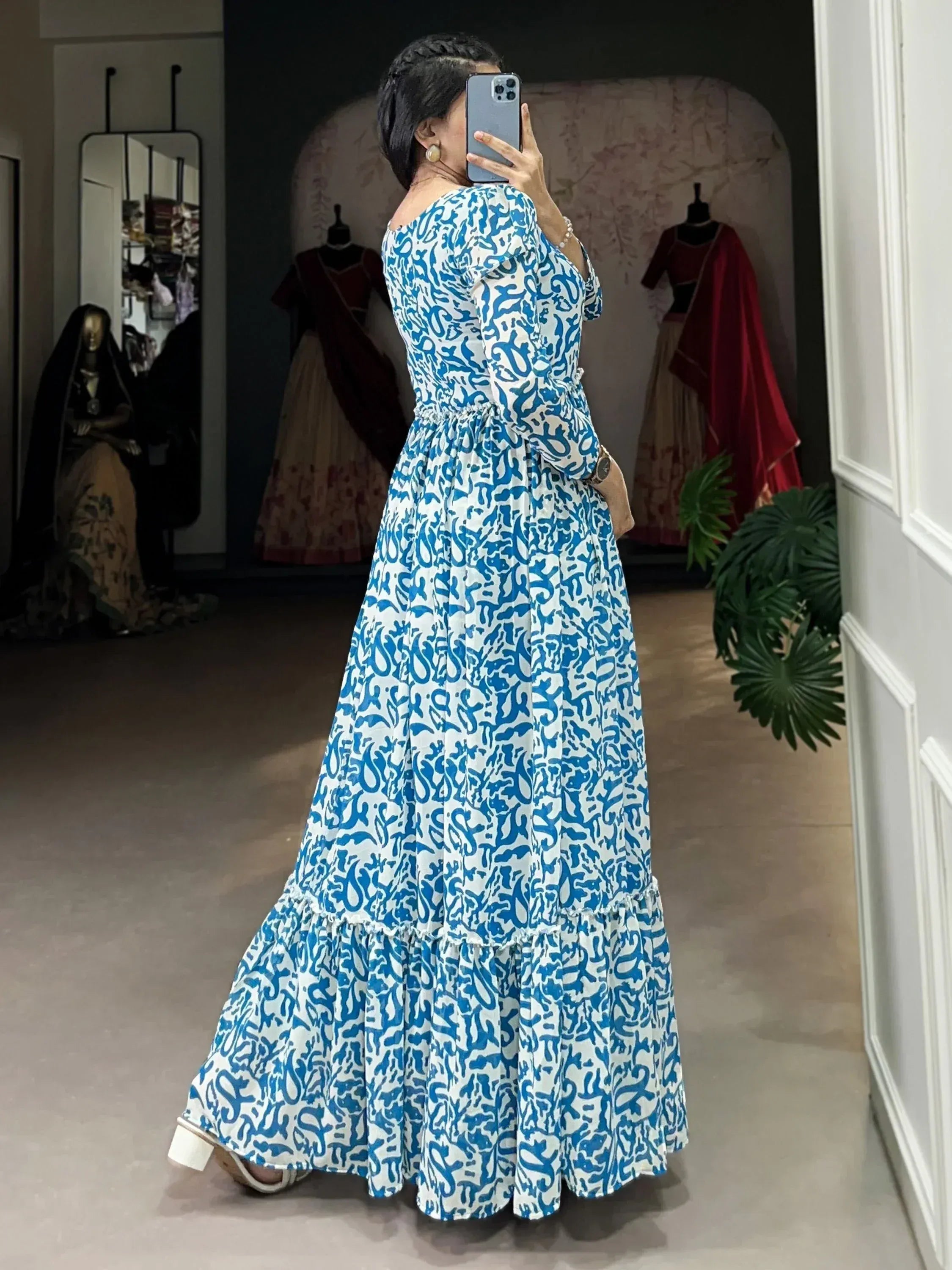 Blue and white printed ethnic gown with flared ruffle hem, off-shoulder design, perfect for Indian occasions