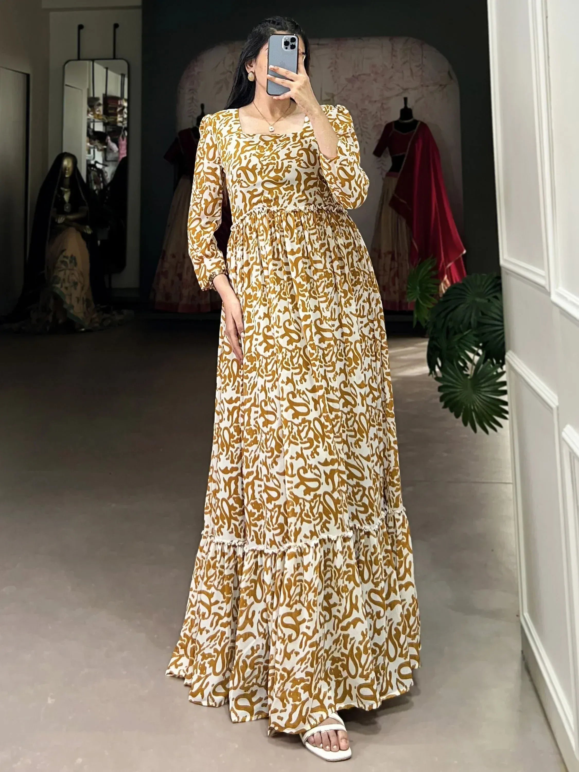 Elegant ethnic gown with gold abstract print, tiered skirt, and puff sleeves for festive occasions