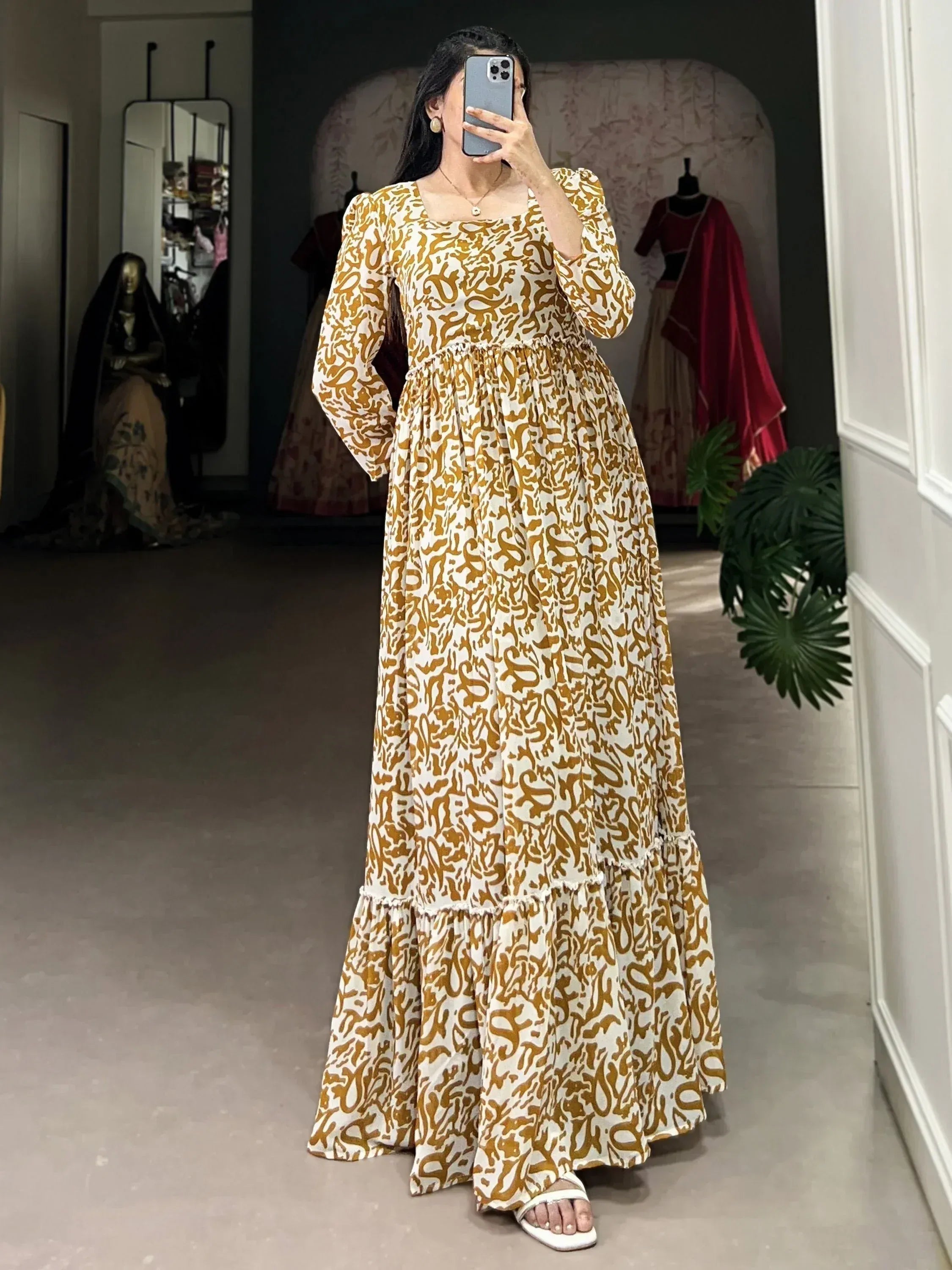 Woman in mustard and white printed ethnic gown with puff sleeves, perfect for Indian occasions