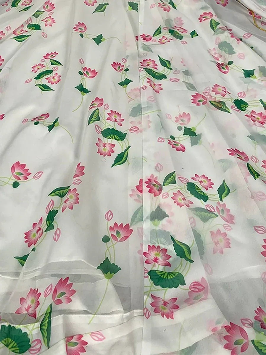 White organza saree with pink lotus floral print and green leaves
