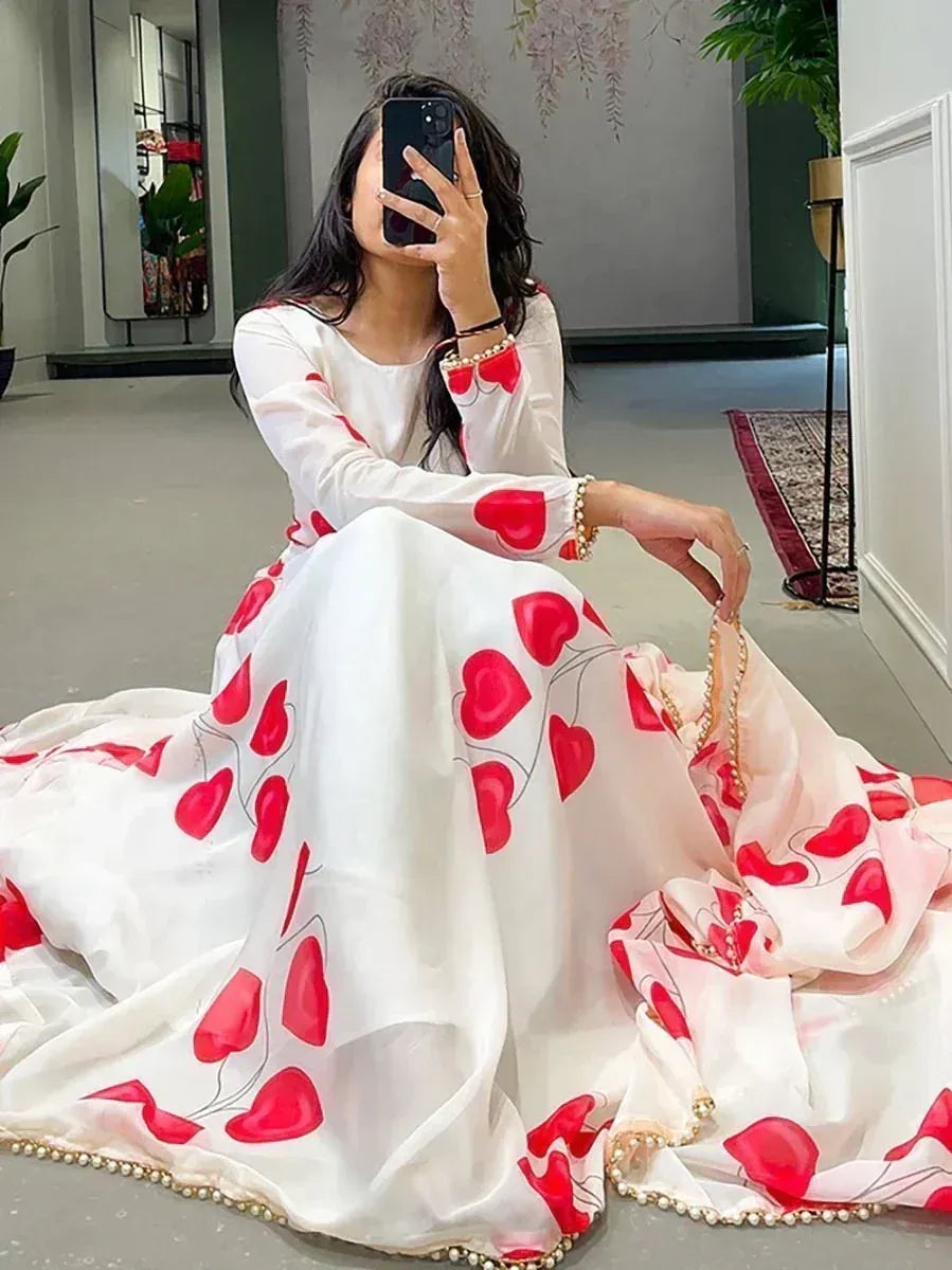 White ethnic gown with red heart print, pearl trim, perfect for Indian occasions and festive wear.
