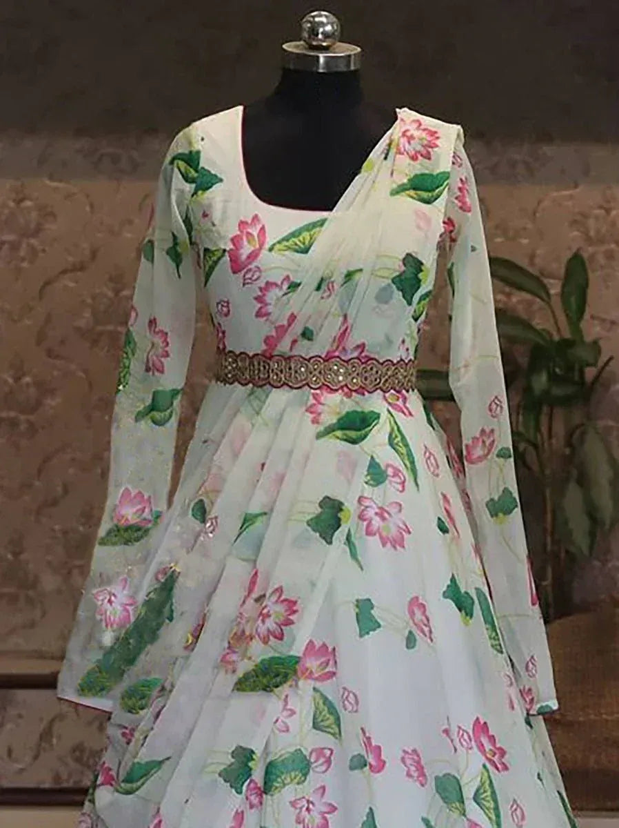White floral print ethnic gown with pink lotus pattern and embroidered belt on mannequin