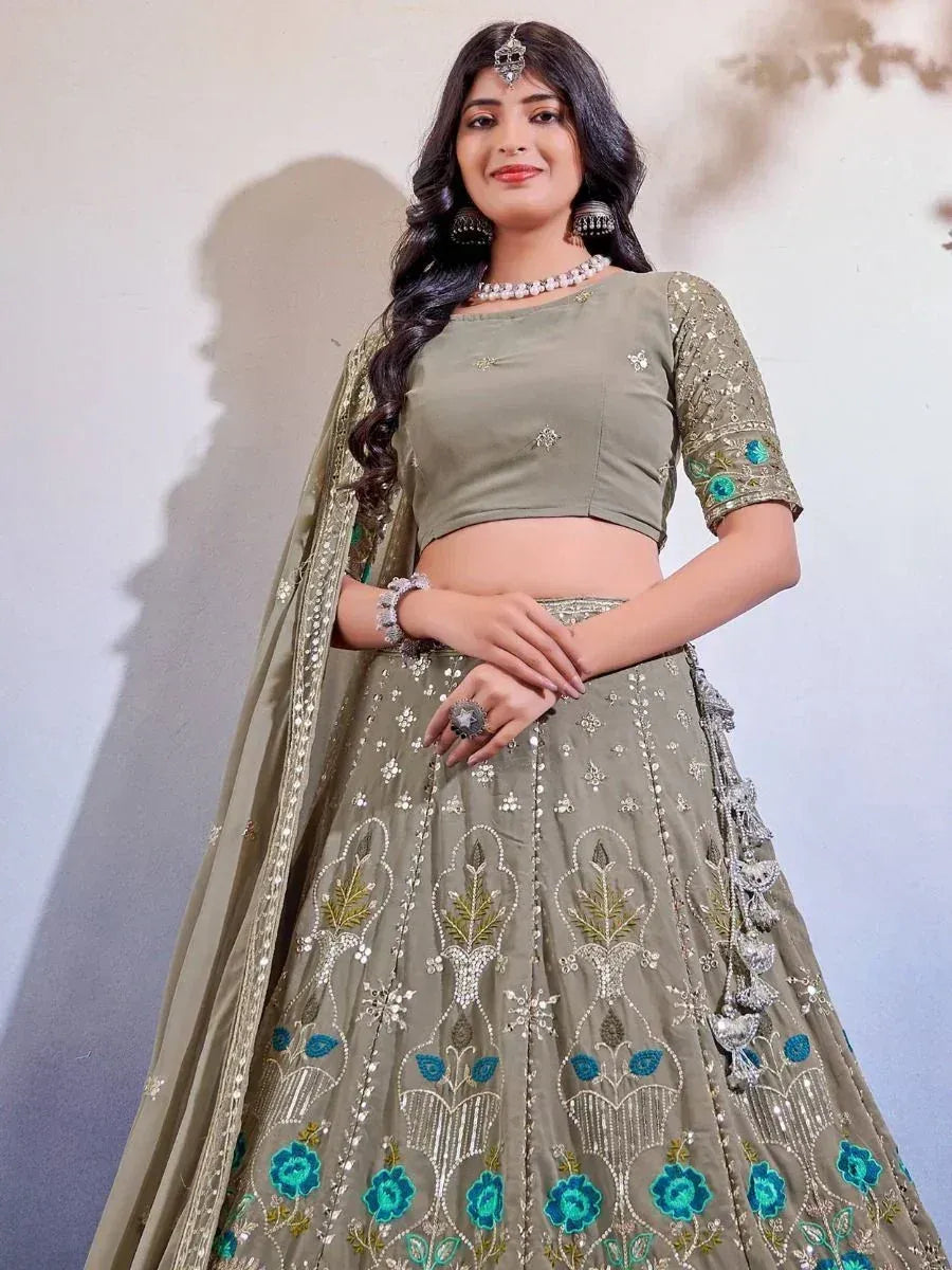 Olive green designer lehenga choli with blue floral embroidery and sequin work, perfect for weddings and parties.