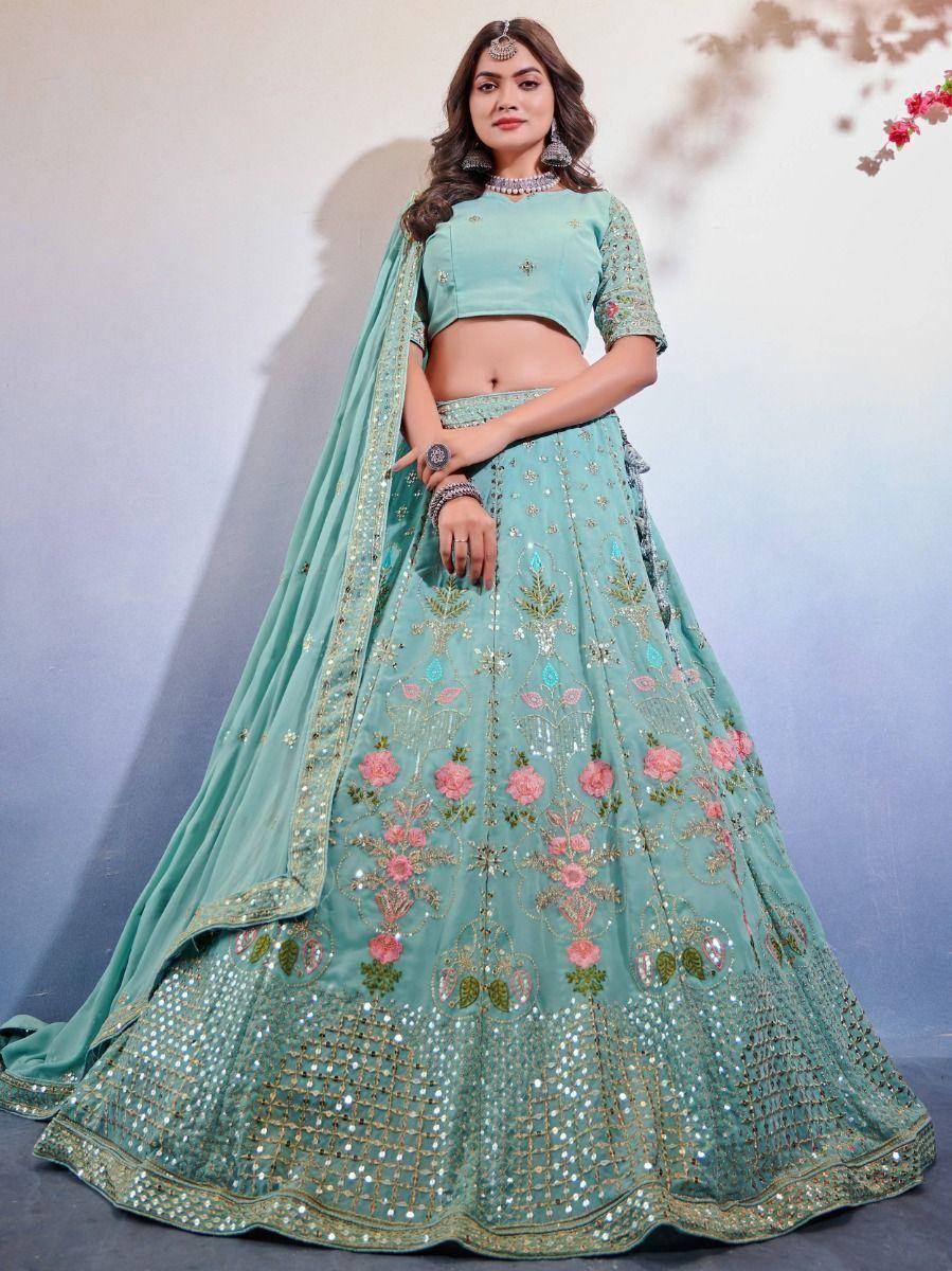Mint green designer lehenga choli with floral embroidery and mirror work, perfect for weddings and parties.