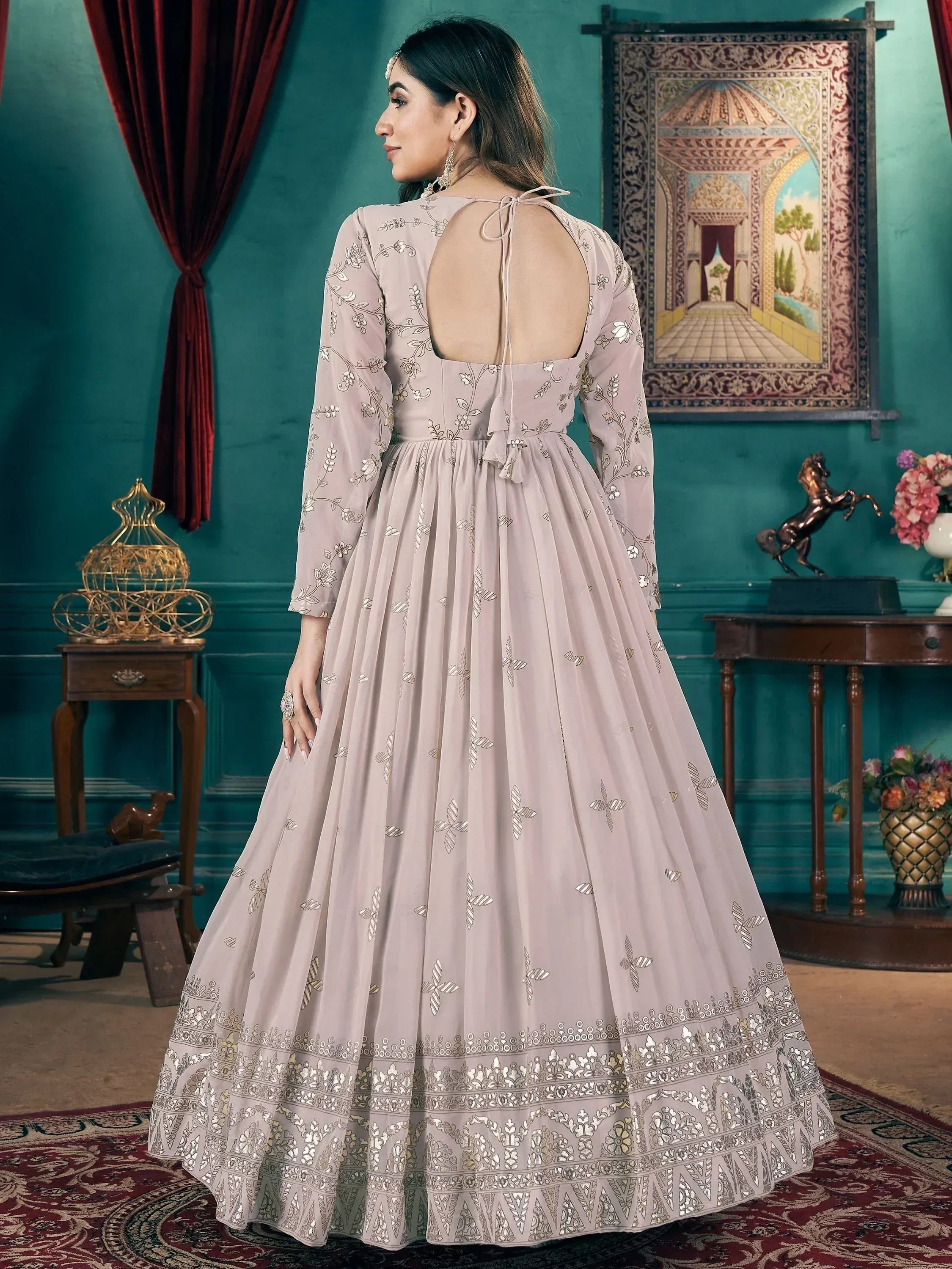 Elegant beige anarkali gown with floral embroidery and open back, perfect for Indian ethnic wear occasions.