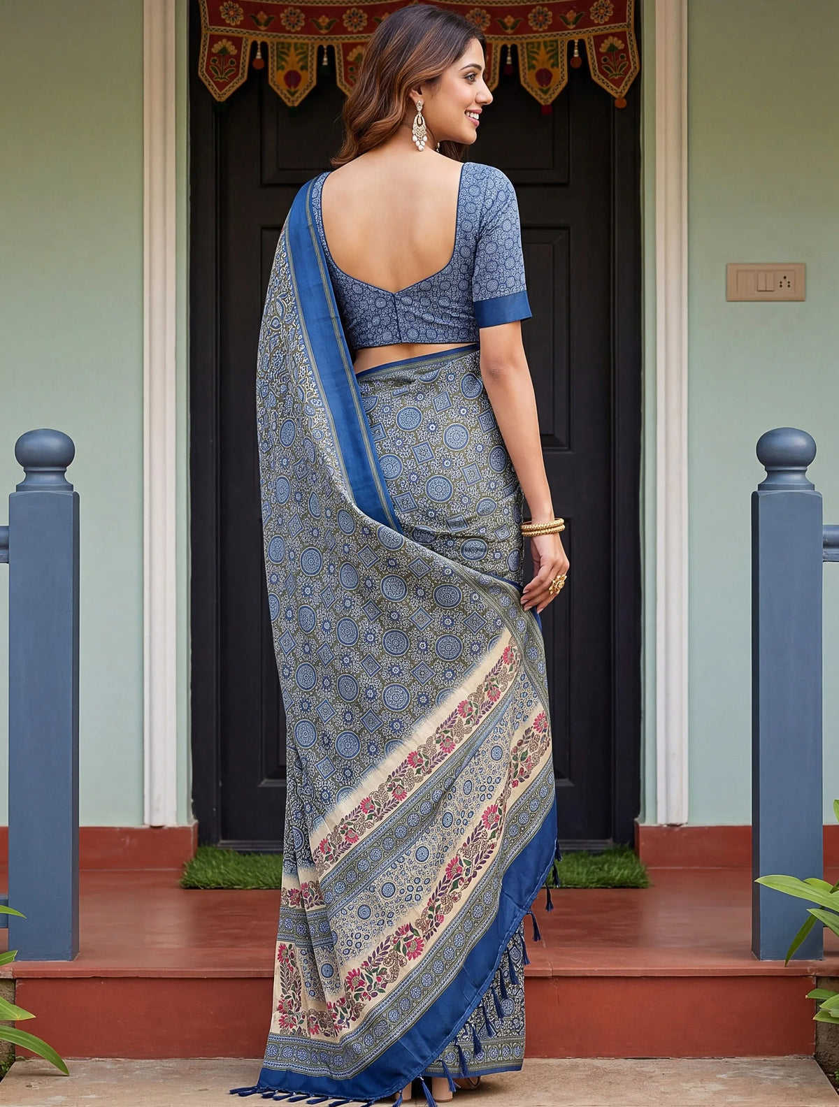 Woman wearing a blue printed designer saree with a matching blouse