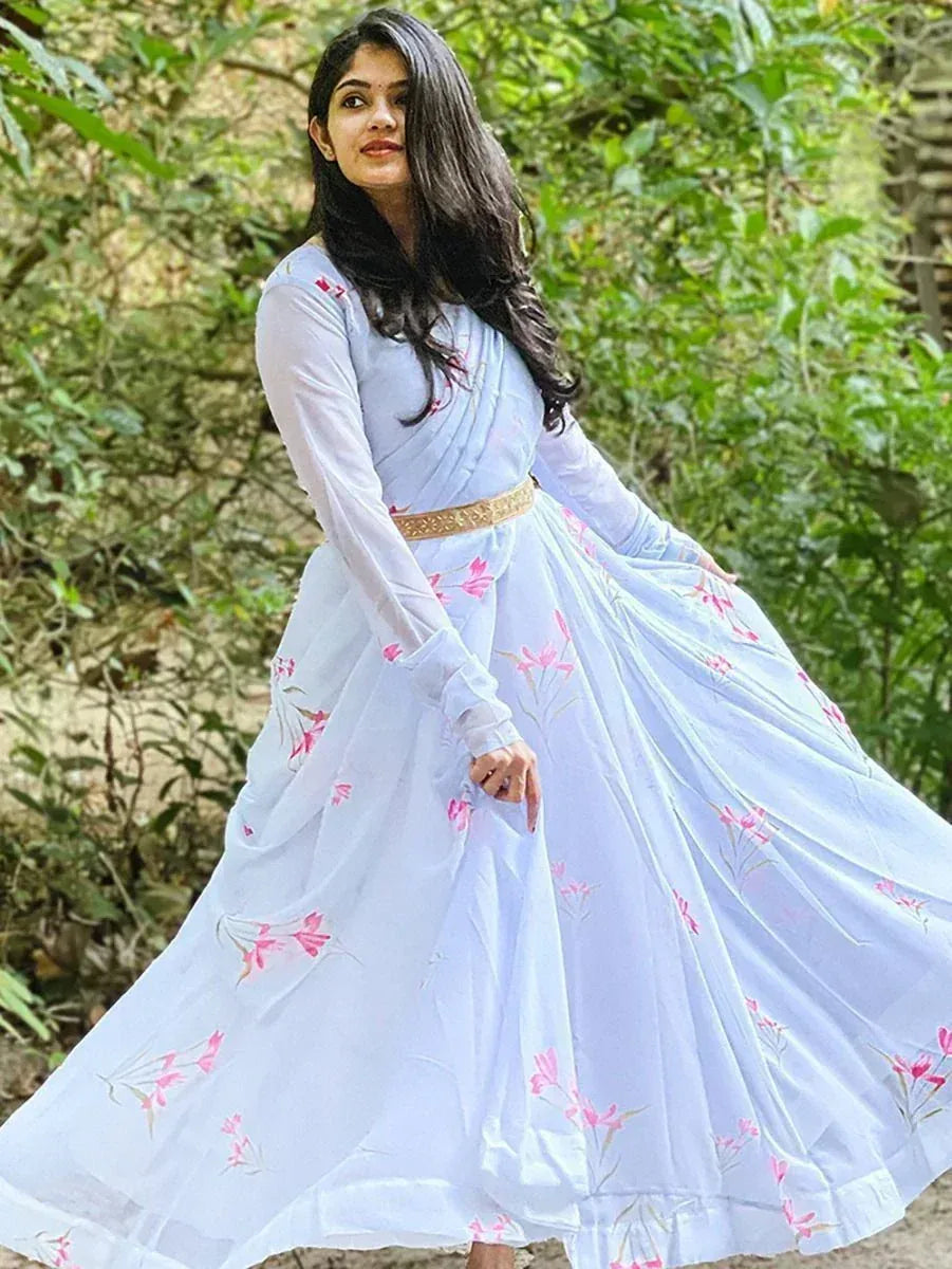 Woman in light blue floral ethnic gown with gold belt, perfect for Indian occasions and events.