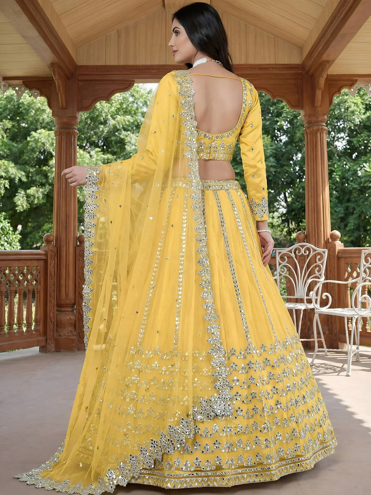 Yellow designer lehenga choli with mirror work, perfect for Indian ethnic wear and festive occasions.
