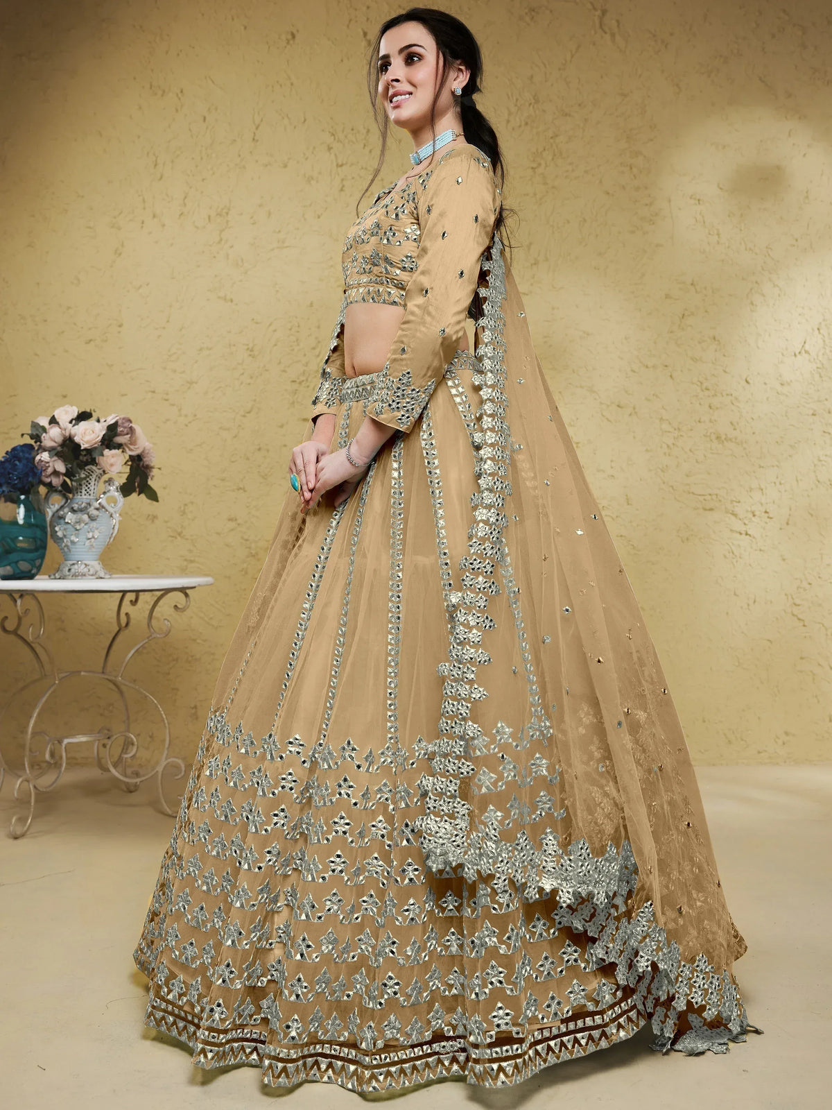 Beige designer lehenga choli with silver mirror work, perfect for Indian weddings and festive occasions