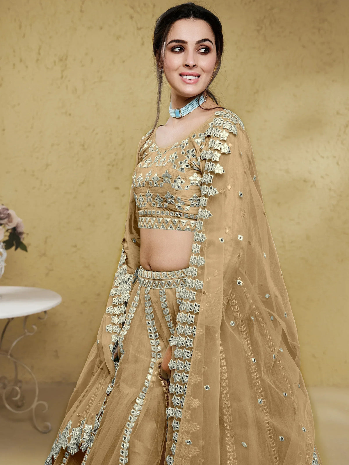 Elegant beige lehenga choli with intricate silver embroidery and sheer dupatta for Indian ethnic wear