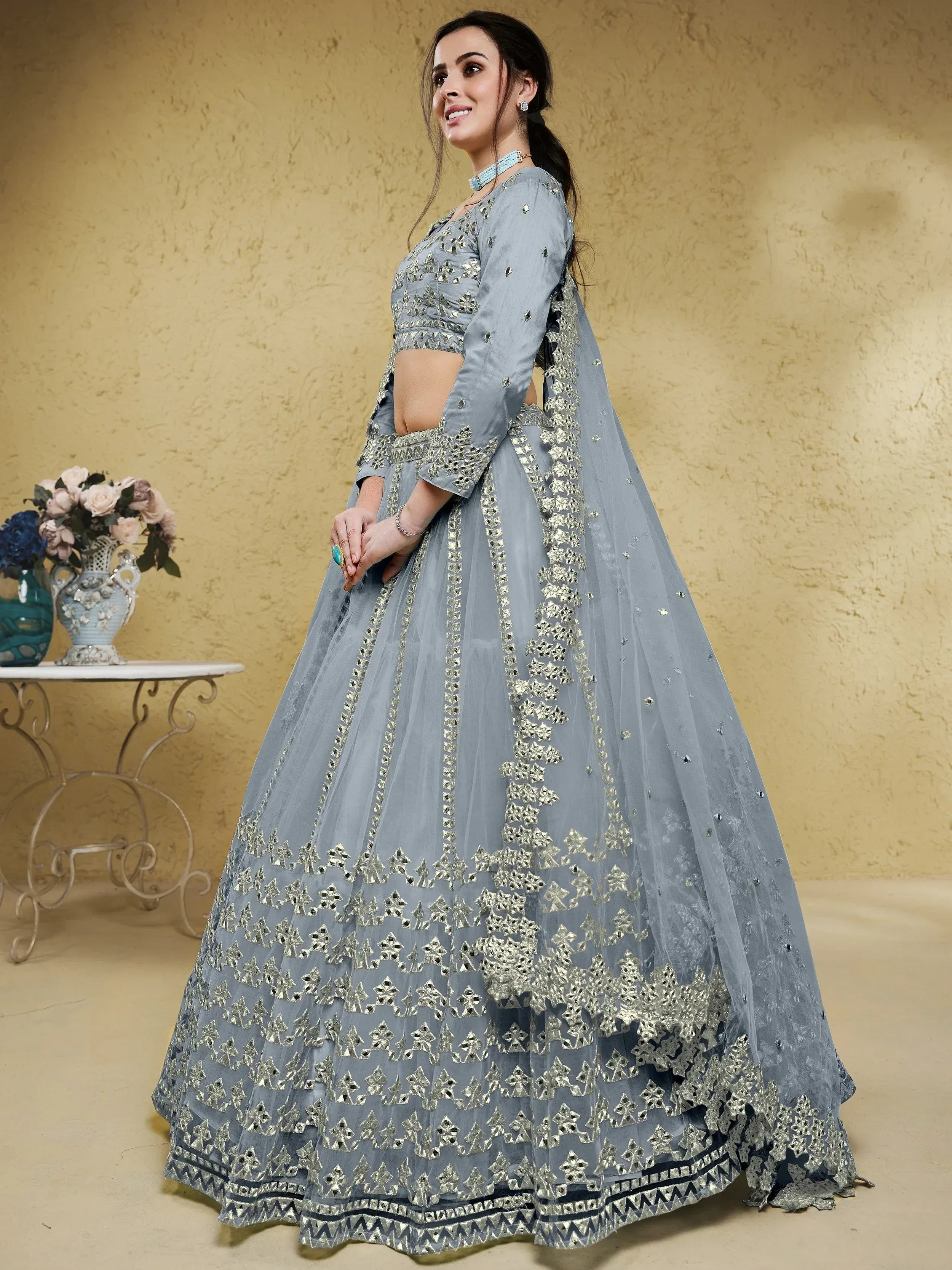 Grey designer lehenga choli with silver mirror work, perfect for Indian ethnic wear occasions.