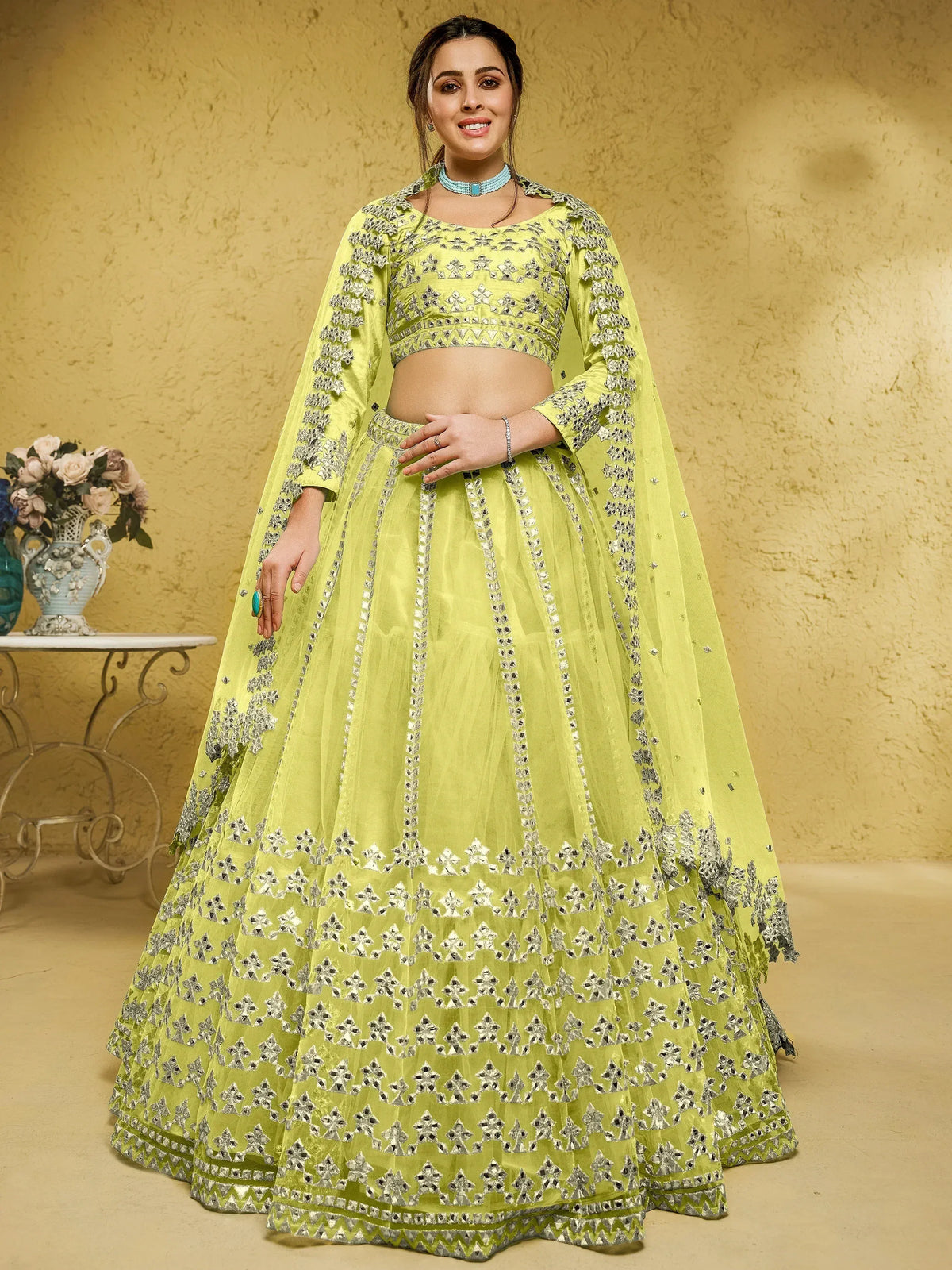 Lime green designer lehenga choli with mirror work and cape sleeves for Indian ethnic wear
