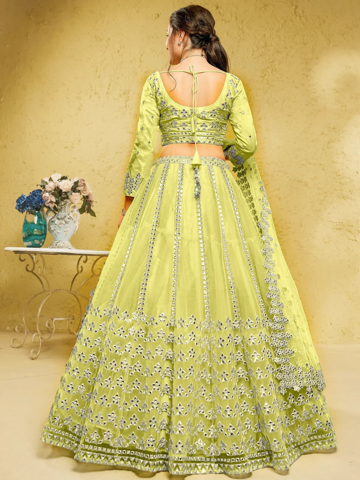 Lime green designer lehenga choli with silver mirror work, back view, ethnic wear for women