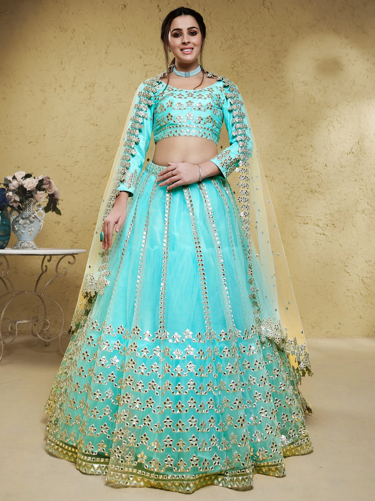 Turquoise designer lehenga choli with mirror work and gold embroidery, perfect for Indian ethnic wear