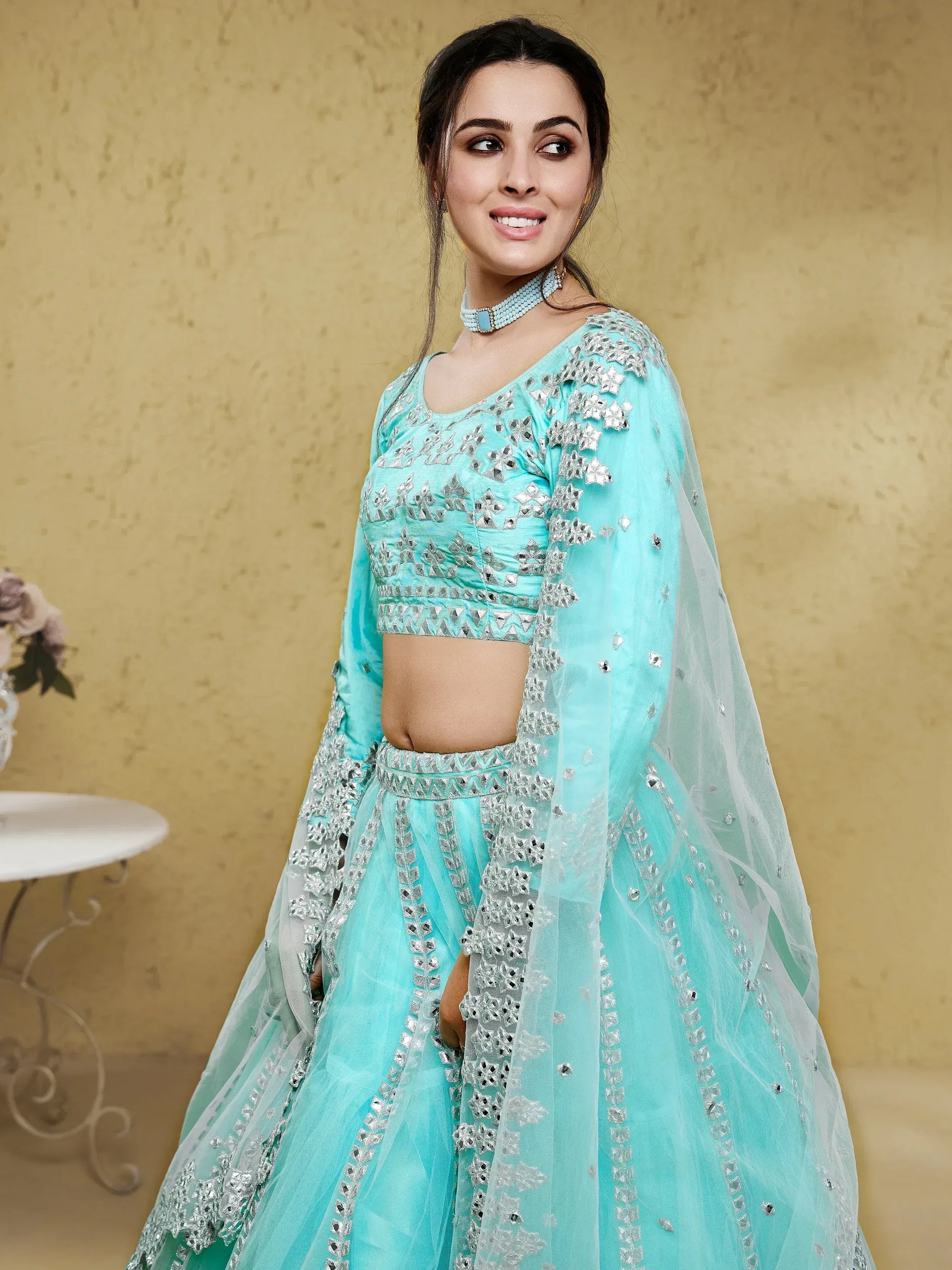 Mint green designer lehenga choli with silver mirror work and sheer dupatta, perfect for Indian ethnic occasions