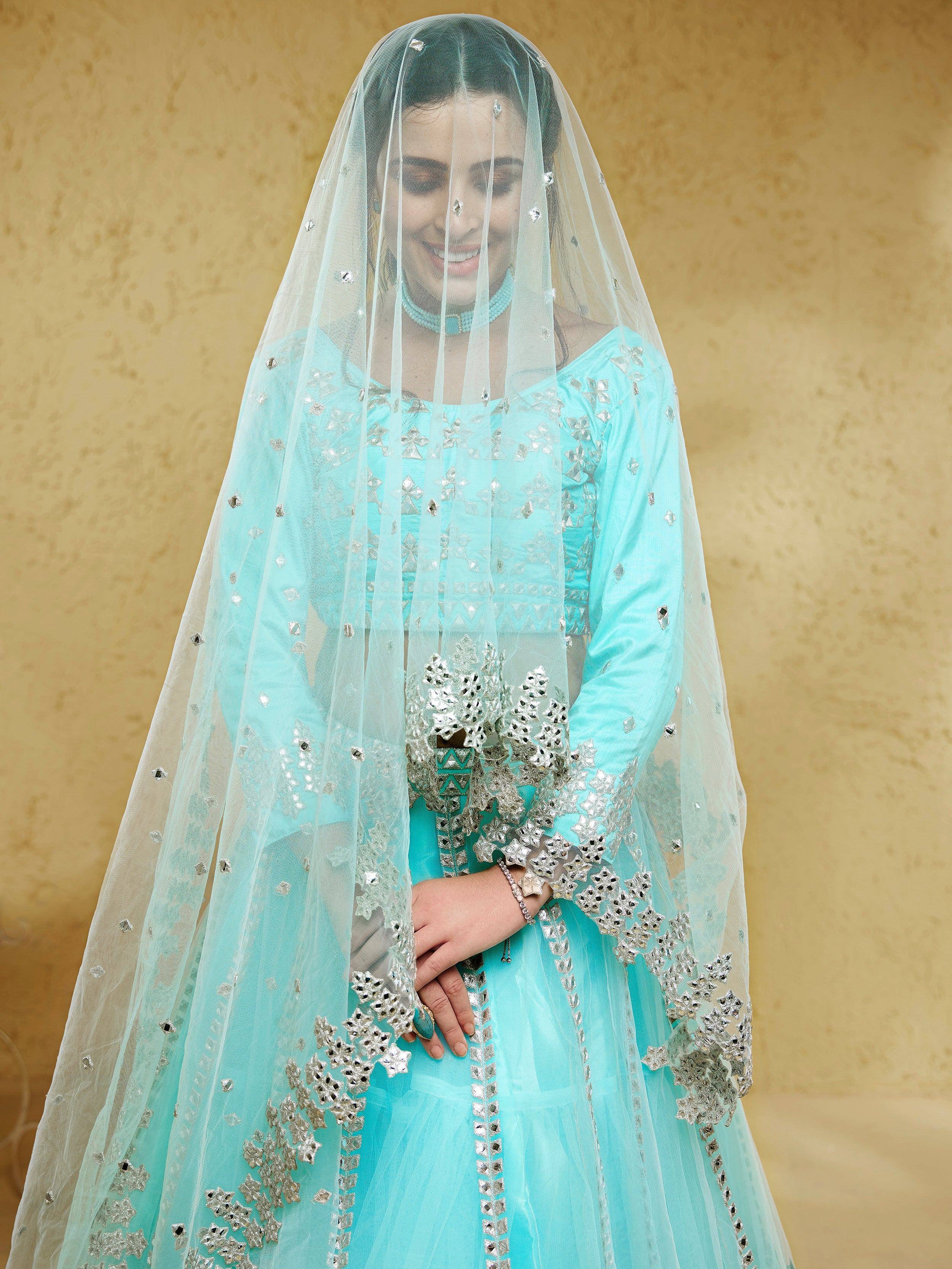 Mint green ethnic gown with silver mirror work and sheer dupatta for Indian weddings