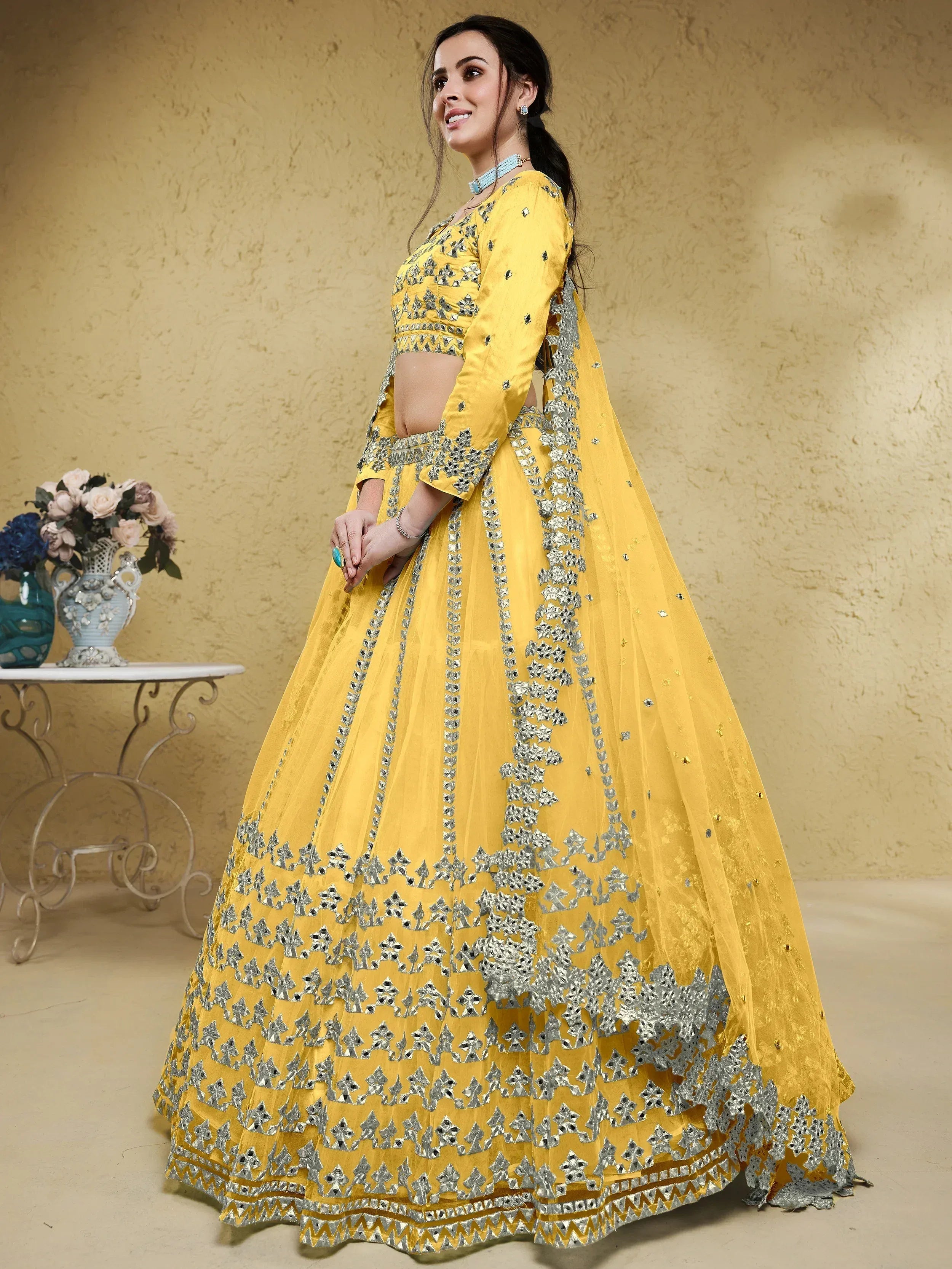 Yellow designer lehenga choli with silver mirror work and floral embroidery for ethnic wear