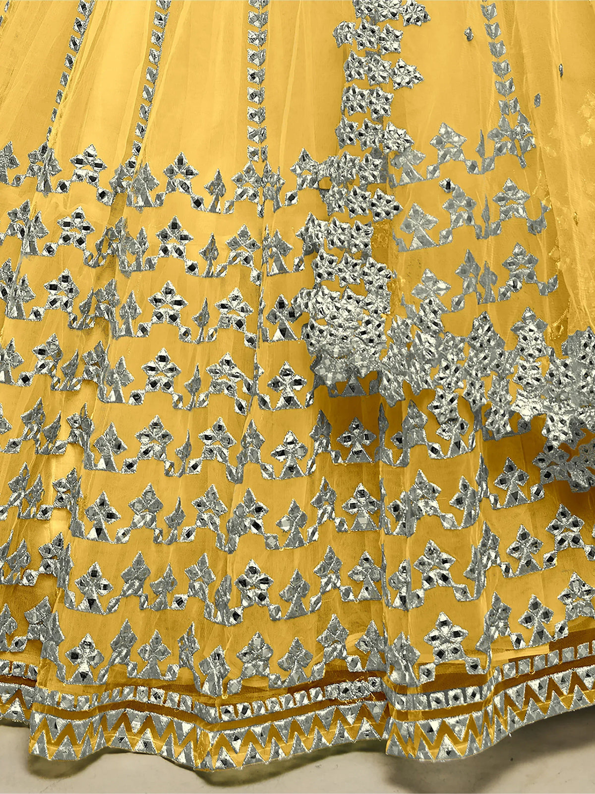 Yellow ethnic lehenga with silver mirror work and intricate embroidery details