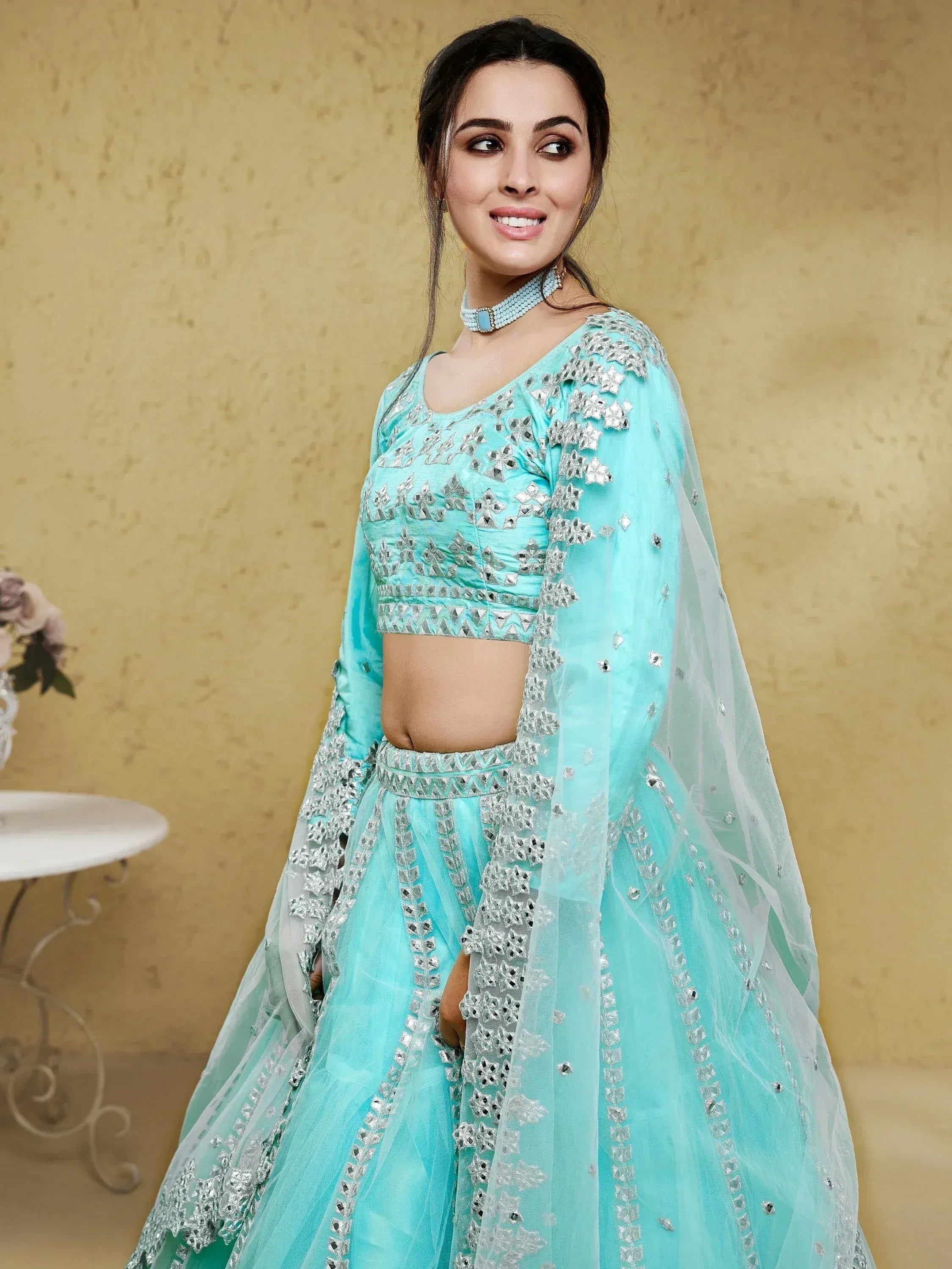 Turquoise designer lehenga choli with silver mirror work and sheer dupatta for Indian ethnic wear