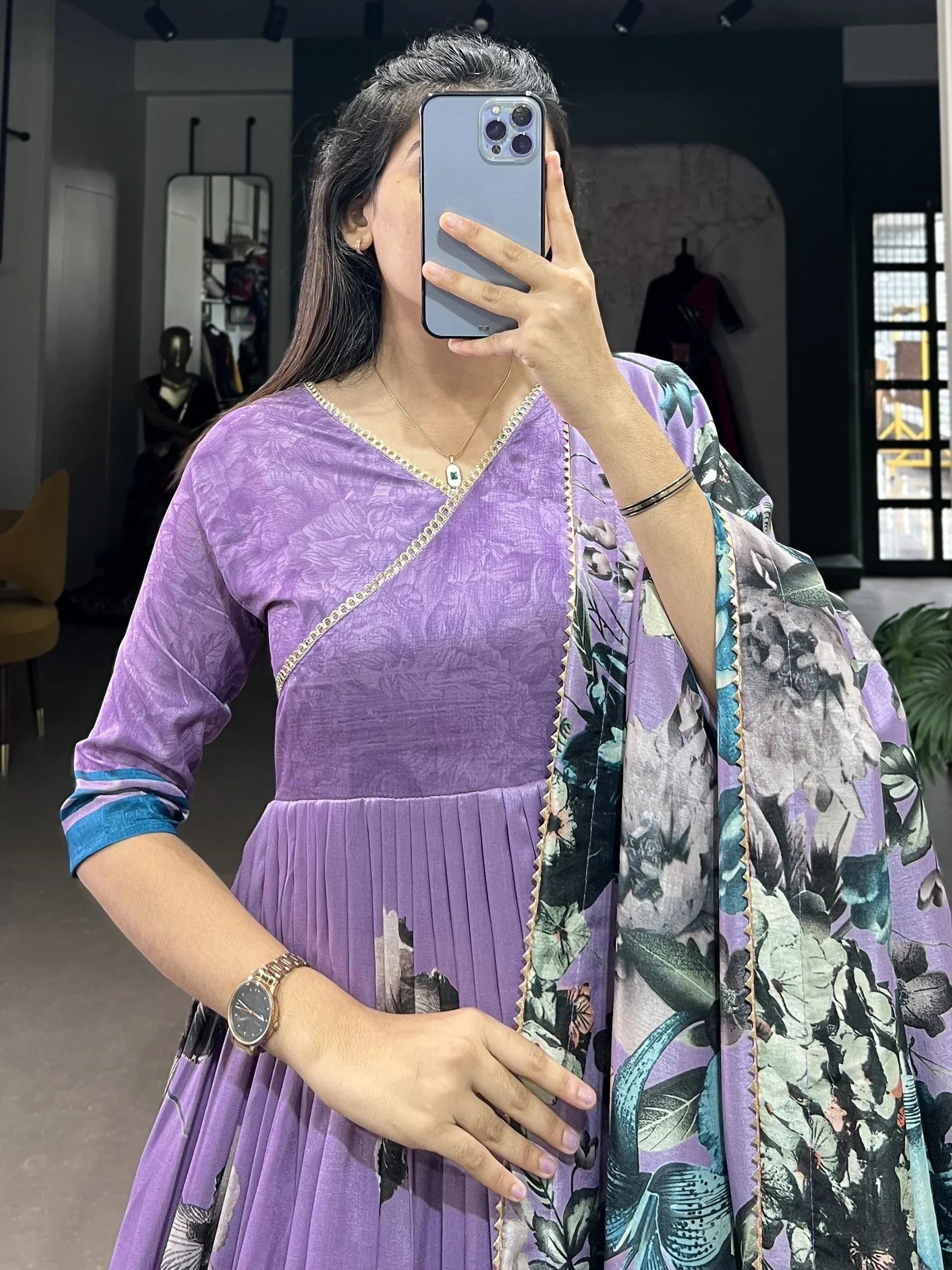 Purple floral print ethnic gown with gold trim, pleated skirt, and matching dupatta for women