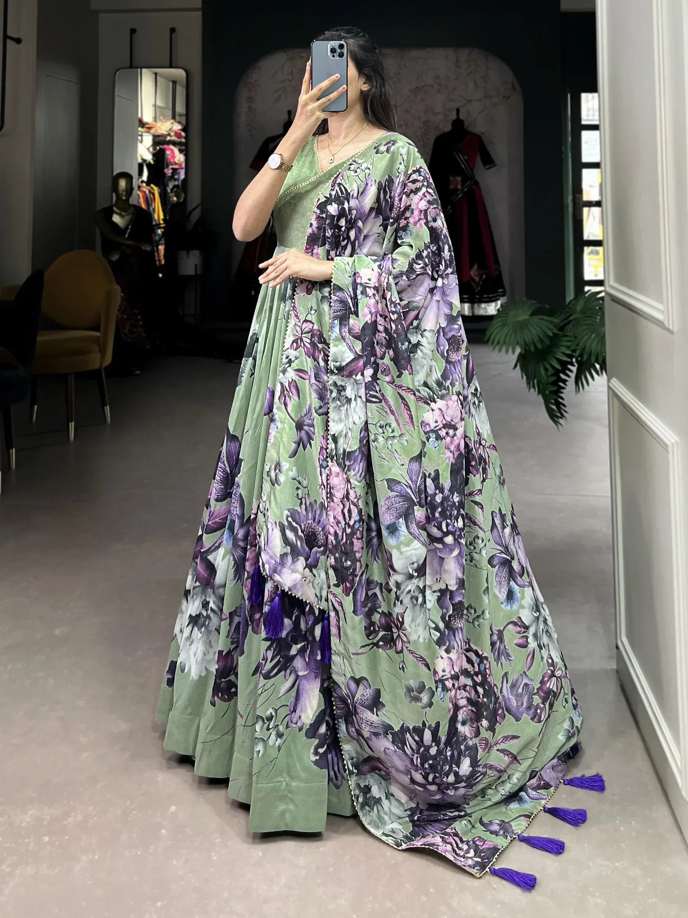 Green floral printed Indian ethnic gown with purple tassels, perfect for festive occasions