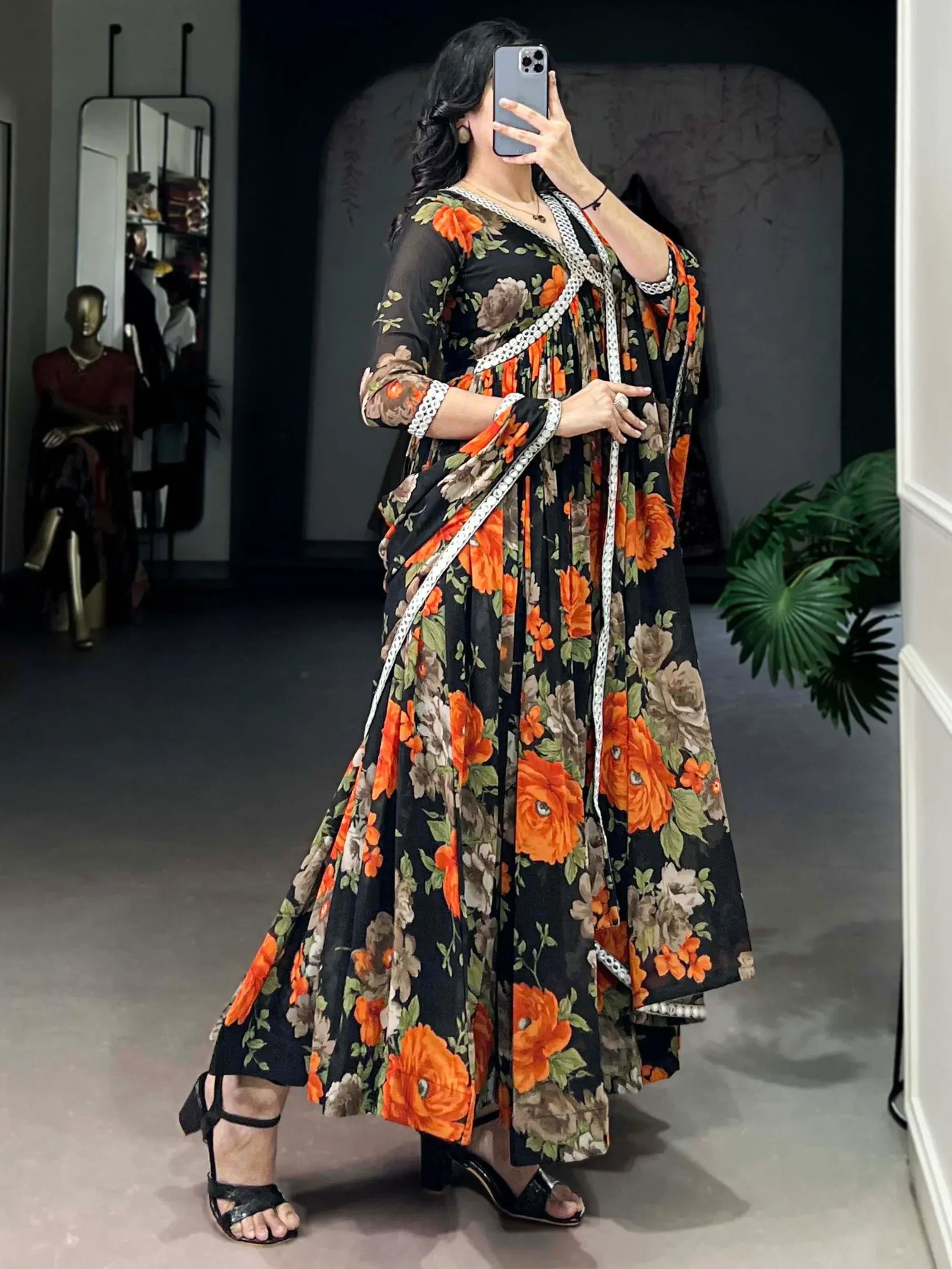 Black floral ethnic gown with orange rose print, white lace trim, styled for Indian wear