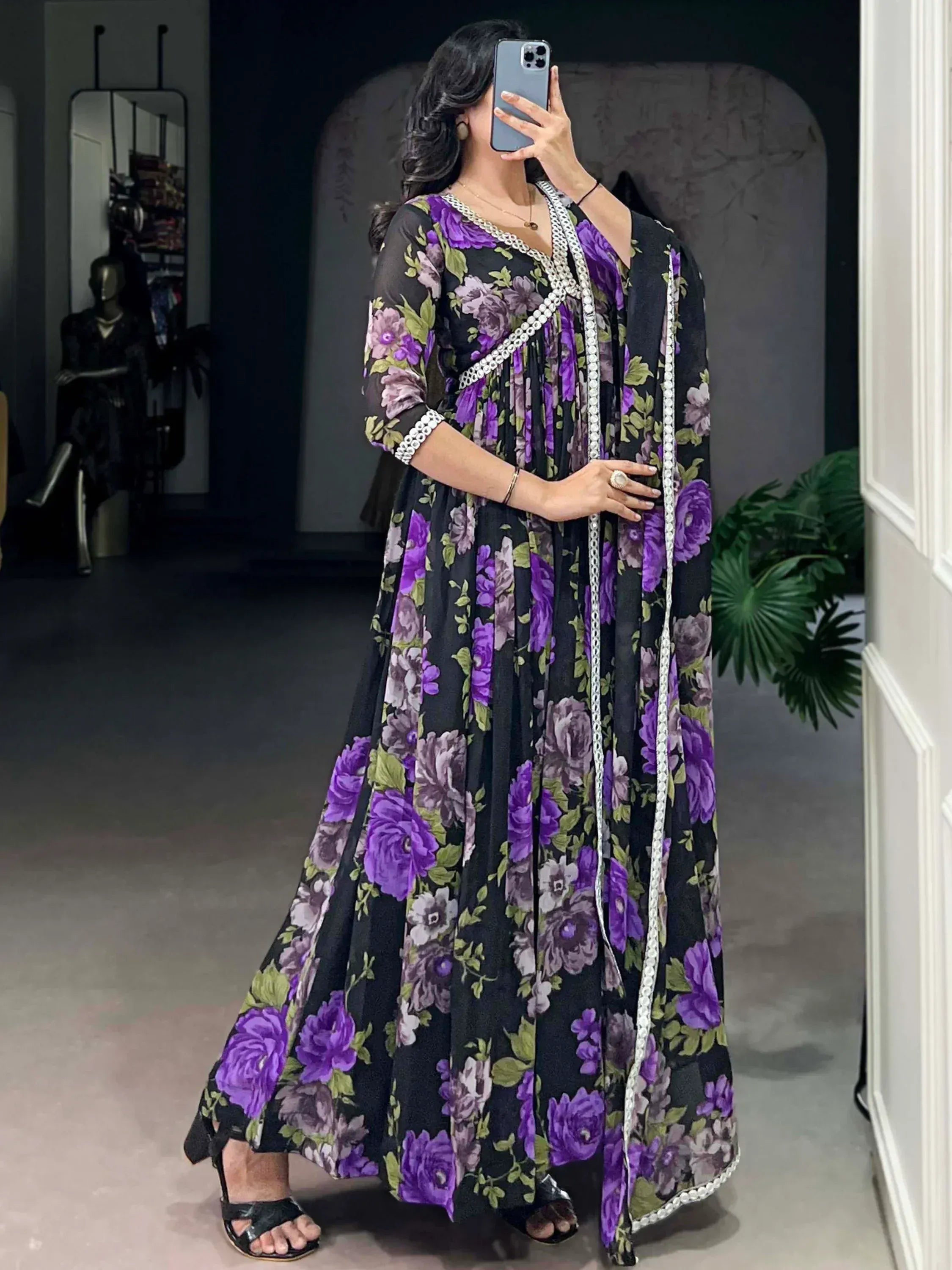 Purple floral print ethnic gown with white lace trim, perfect for Indian occasions and parties.