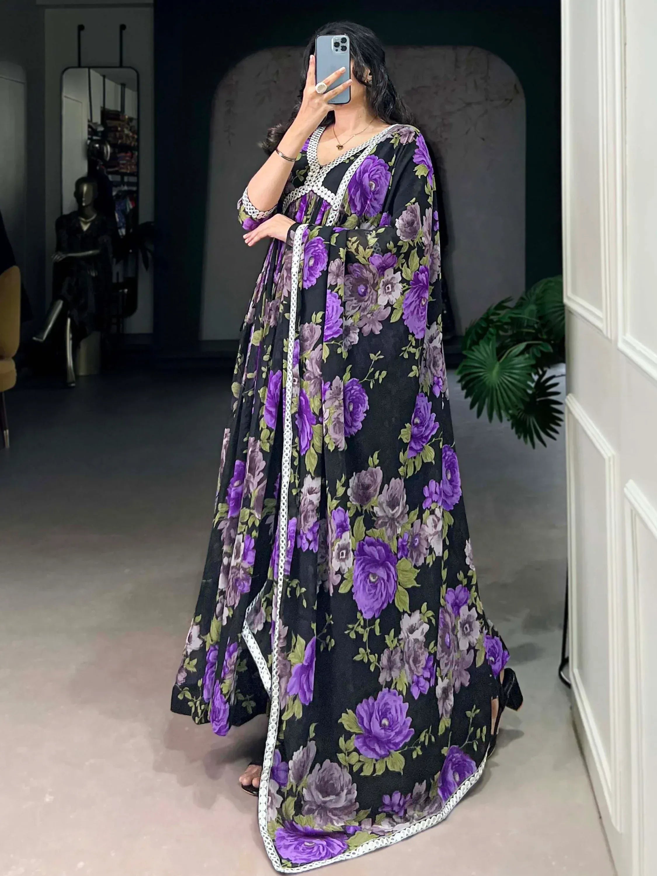 Black and purple floral ethnic gown with white lace trim, perfect for Indian occasions.