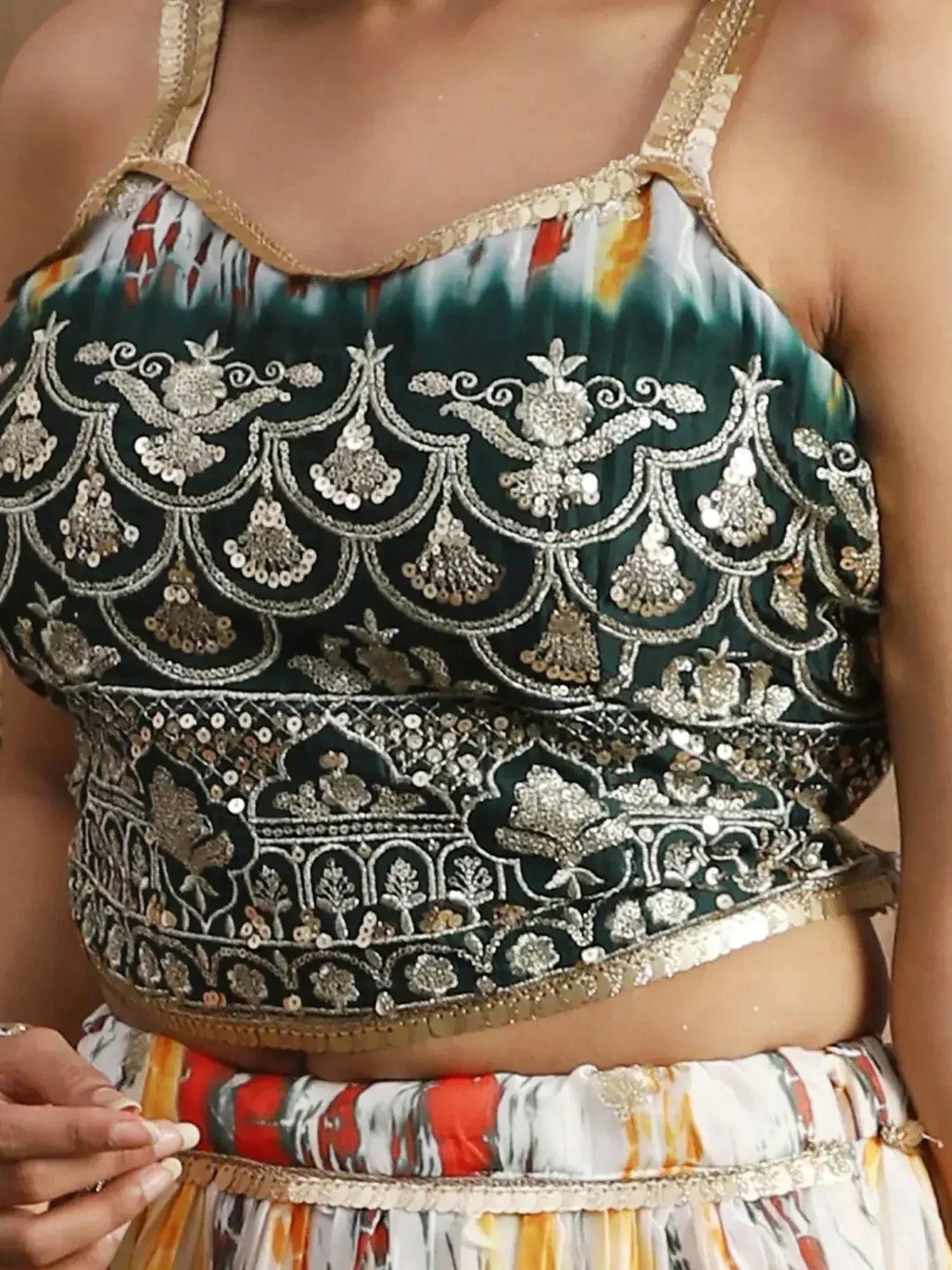 Green embroidered lehenga choli top with gold sequin detailing and floral motifs, ethnic Indian wear