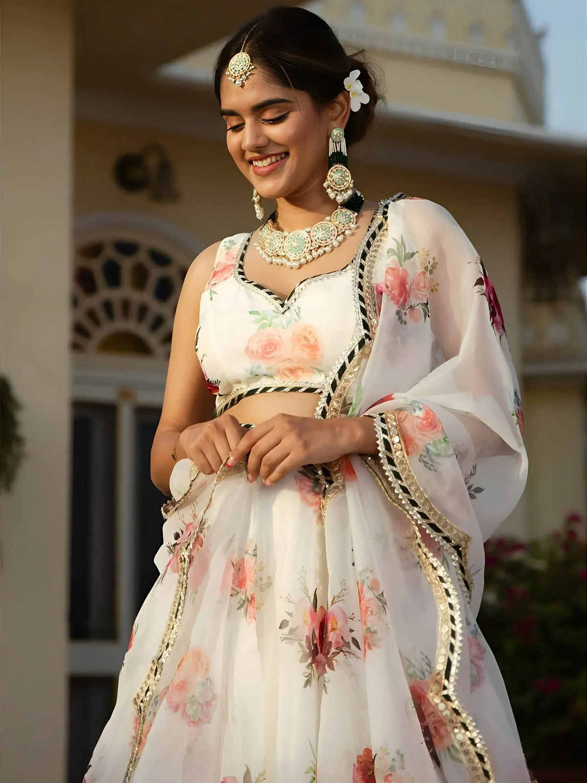 White floral lehenga choli with gold trim, perfect for Indian ethnic wear and festive occasions.