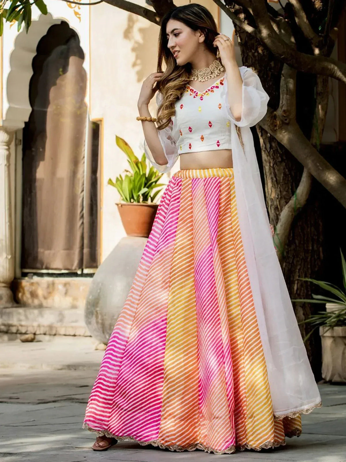 Colorful striped lehenga with white blouse and dupatta, perfect for Indian ethnic wear