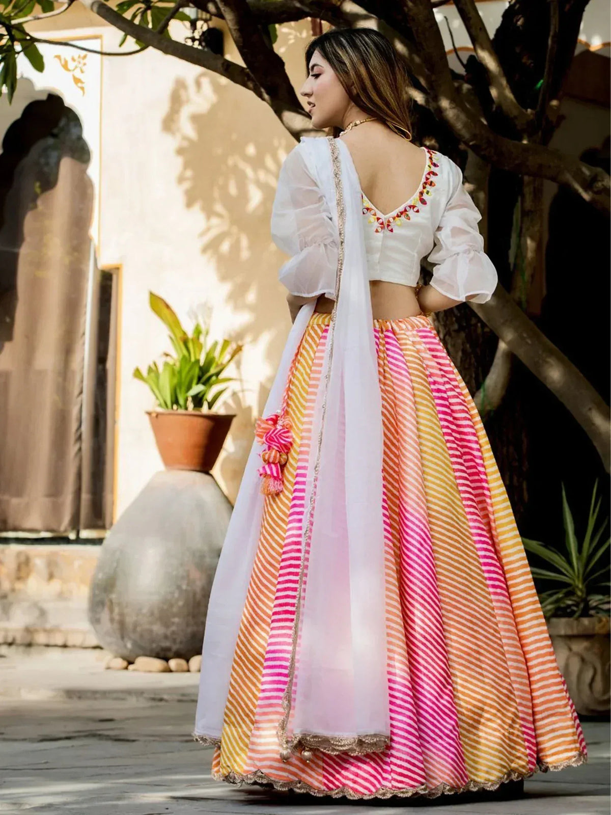 Colorful striped lehenga choli with white blouse and dupatta, perfect for Indian ethnic wear
