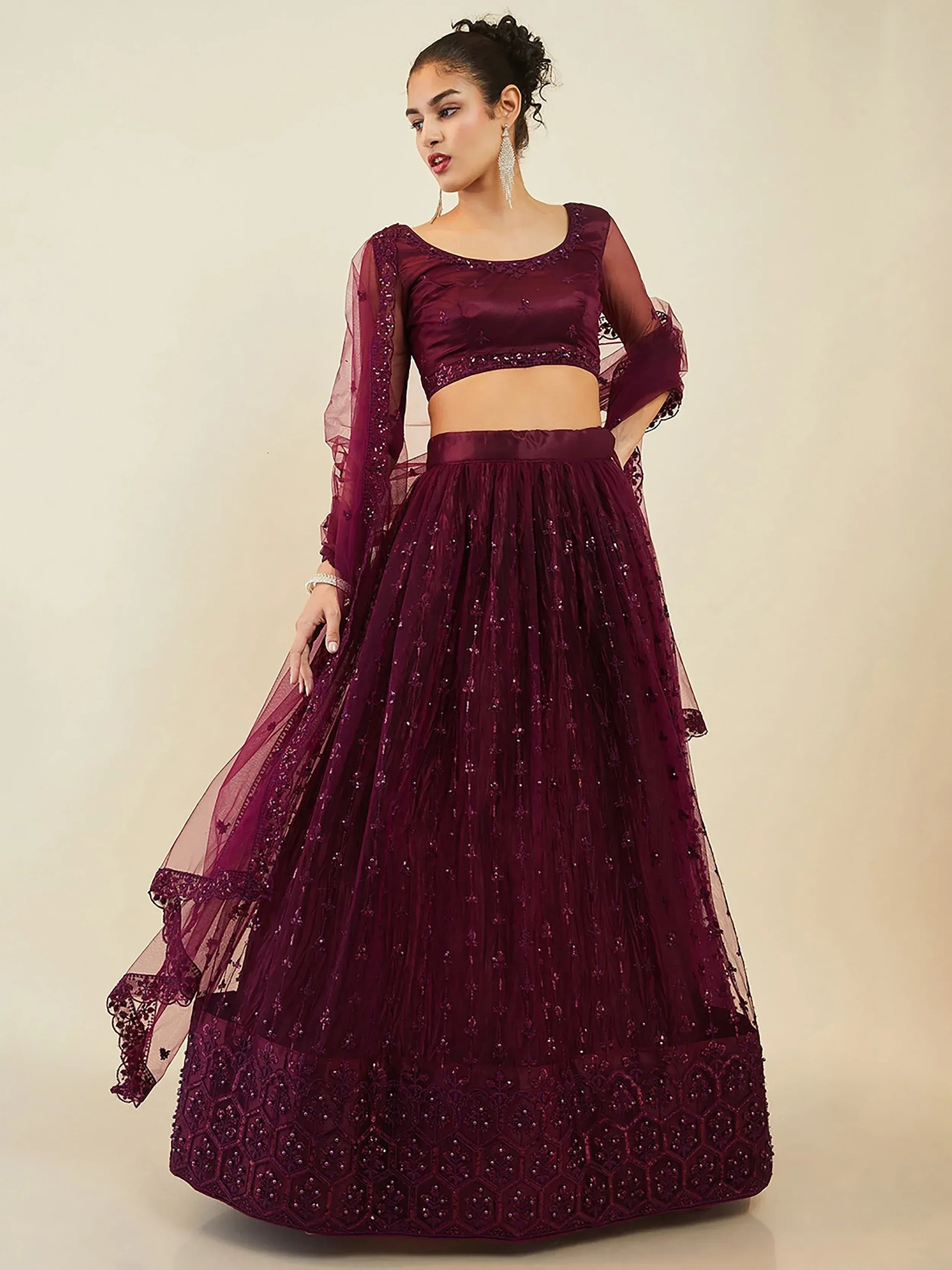 Elegant maroon lehenga choli with intricate embroidery and sheer sleeves for festive occasions