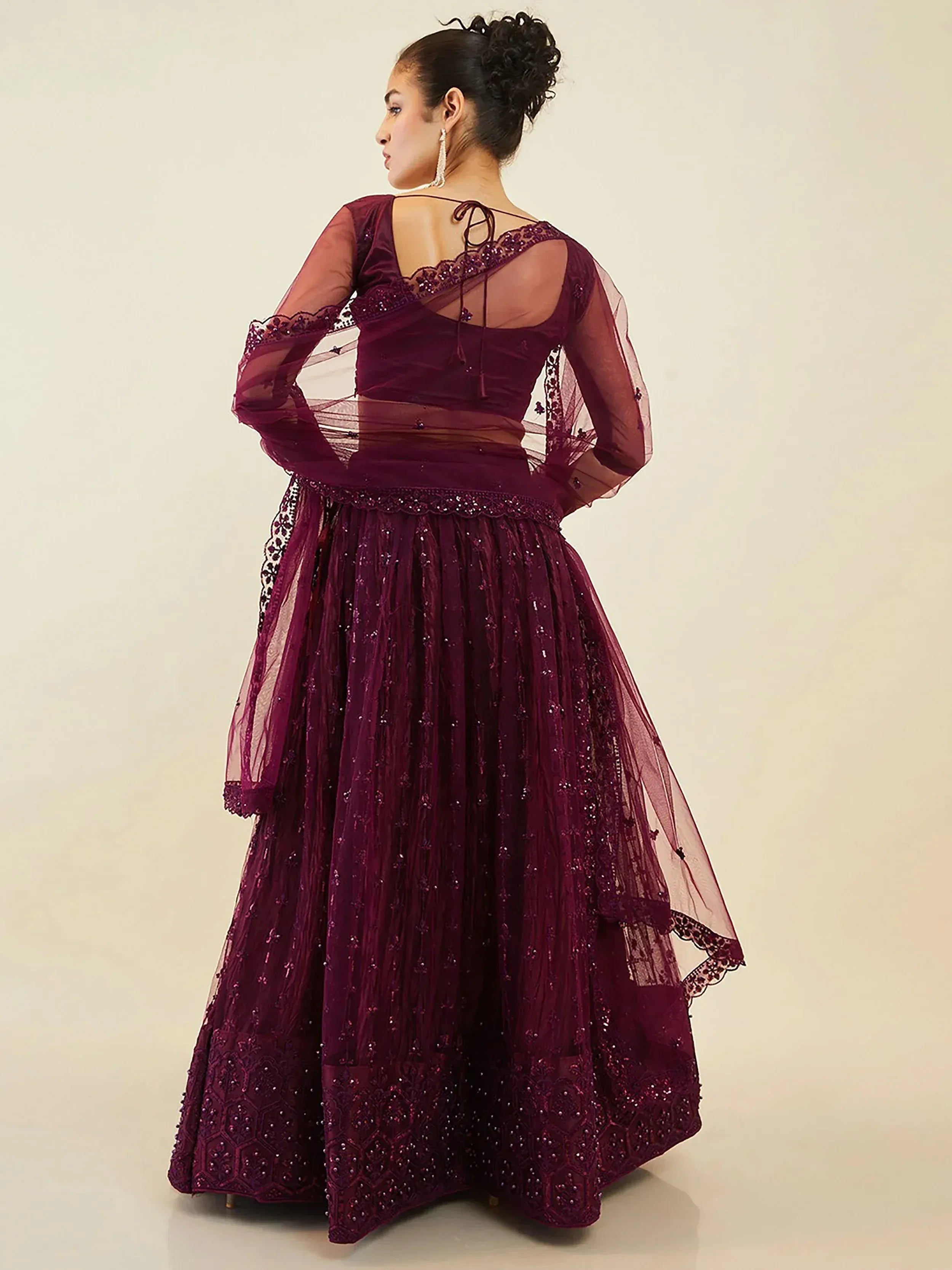 Elegant maroon lehenga choli with sheer sleeves and intricate embroidery for festive occasions