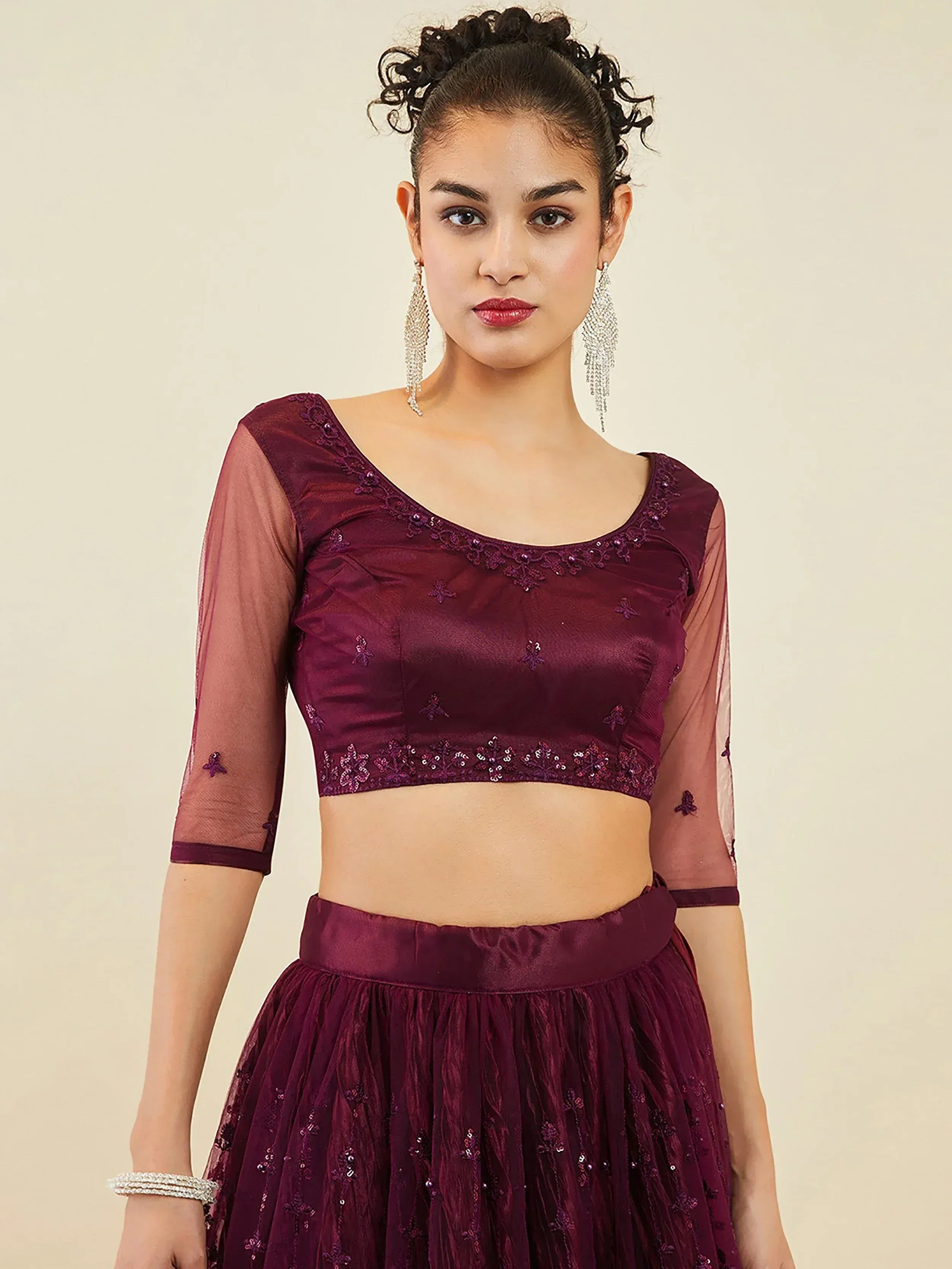 Elegant maroon lehenga choli with sheer sleeves and floral embroidery, perfect for Indian ethnic occasions.