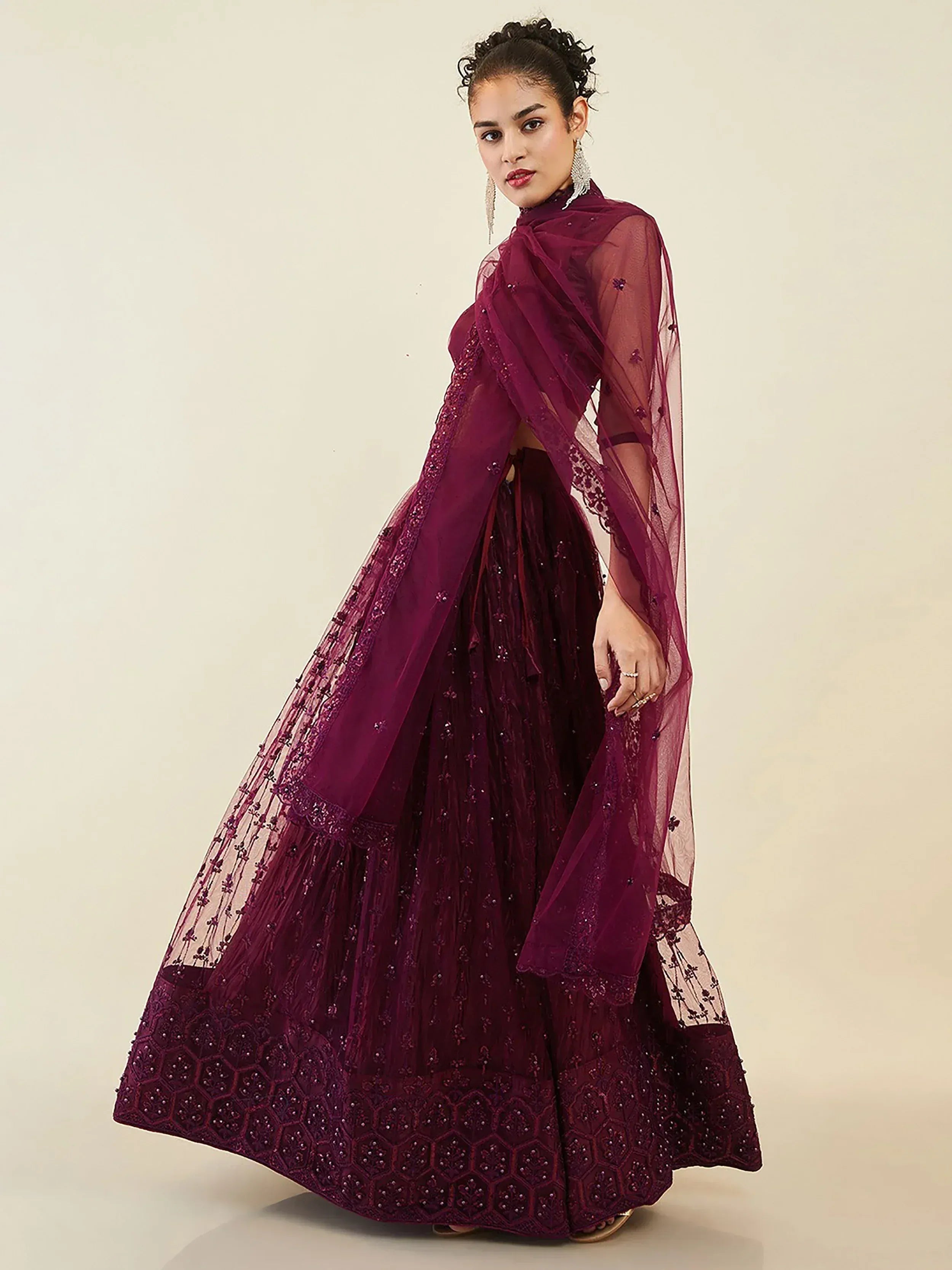 Elegant maroon lehenga choli with intricate embroidery and sheer dupatta for Indian ethnic wear
