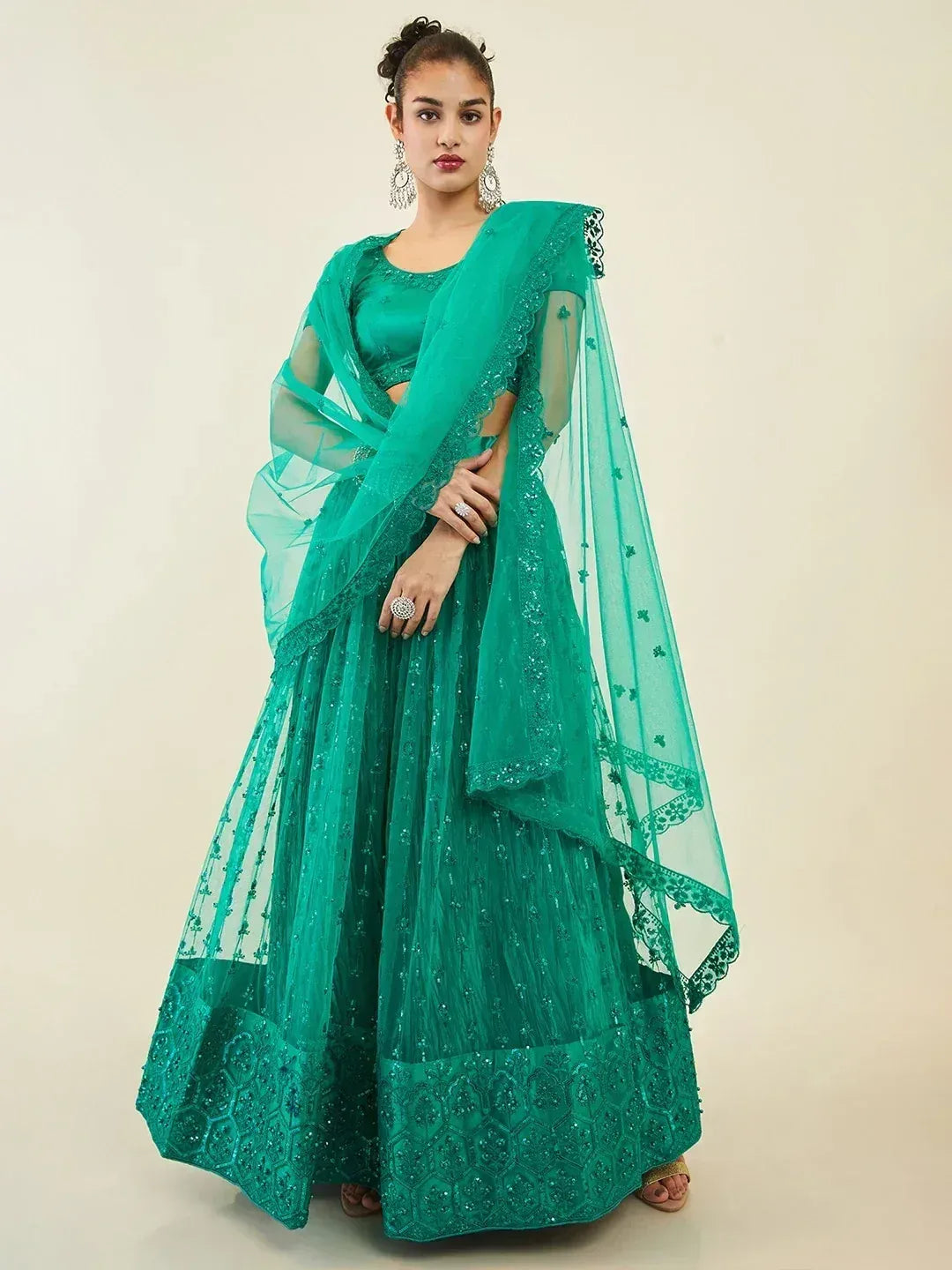 Emerald green designer lehenga choli with intricate embroidery and sheer dupatta for Indian ethnic wear