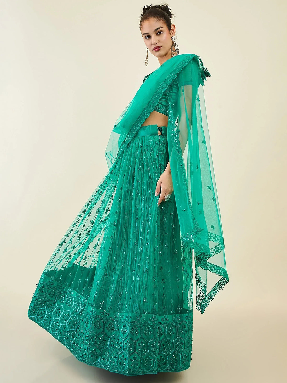 Emerald green designer lehenga choli with intricate embroidery and sheer dupatta for ethnic wear