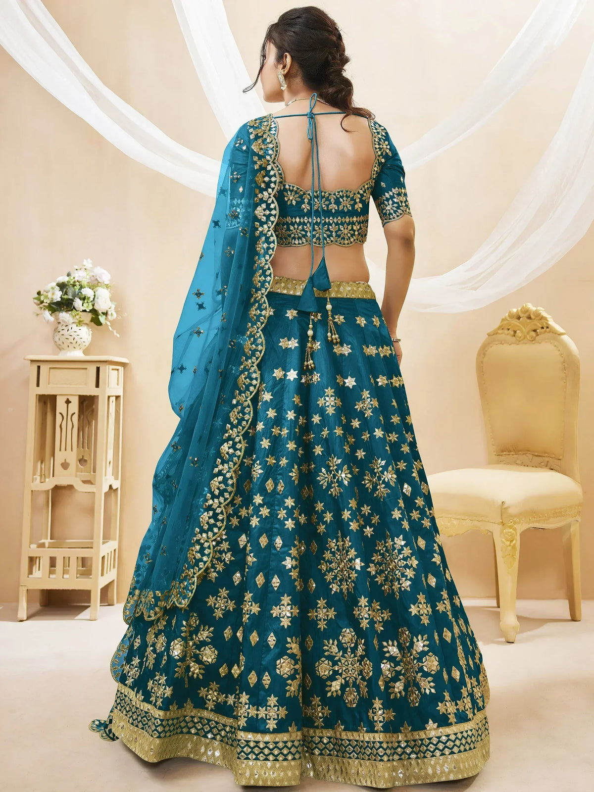 Teal blue lehenga choli with gold floral embroidery, back view, ethnic Indian wear