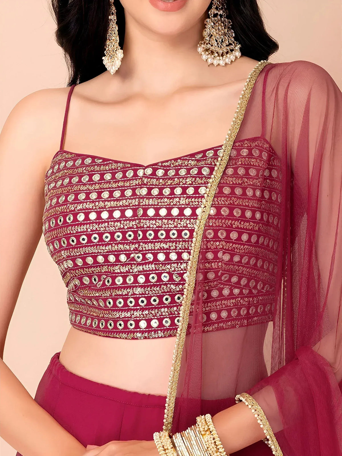 Maroon ethnic crop top with mirror work and gold embroidery, paired with sheer dupatta