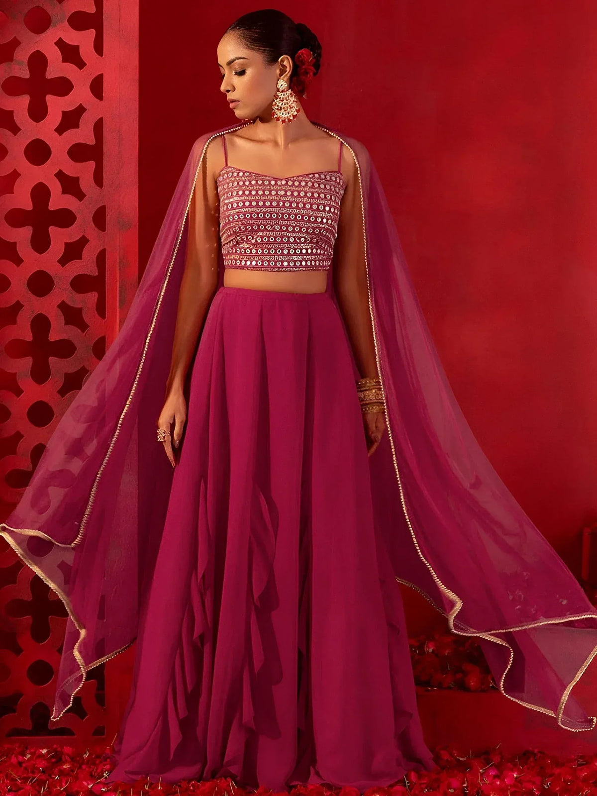 Elegant magenta lehenga choli with mirror work crop top, sheer cape, and gold trim, perfect for Indian ethnic wear occasions.