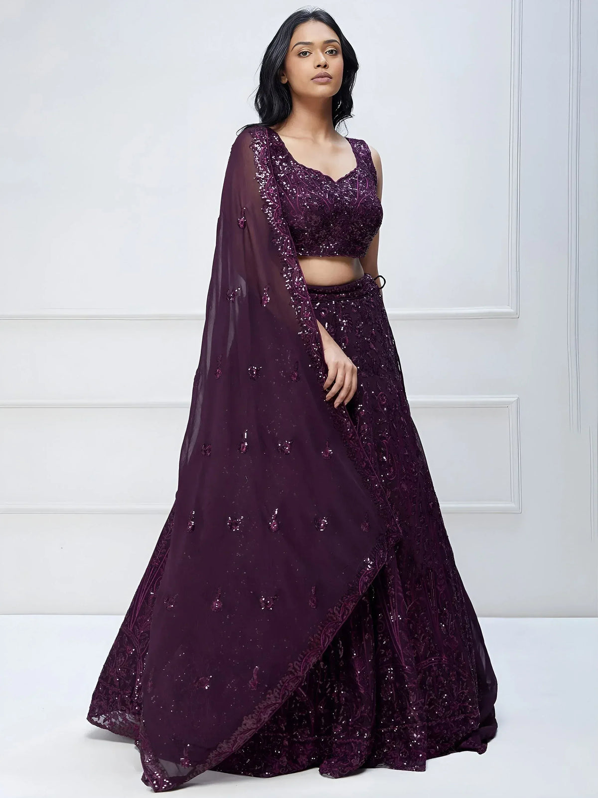 Elegant purple sequin lehenga choli with sheer dupatta, perfect for Indian ethnic occasions.