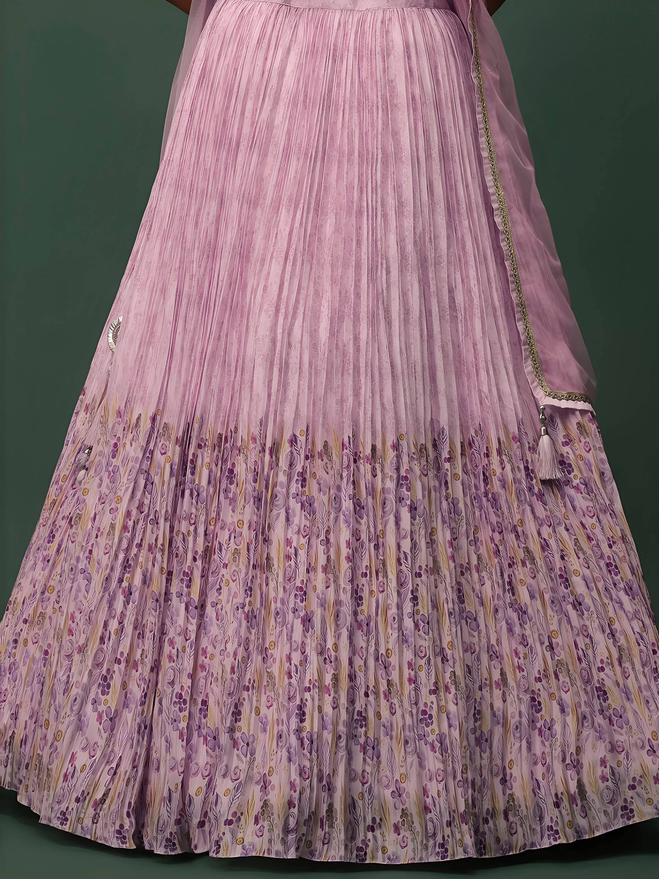 Pink pleated lehenga with floral print and gold trim, ideal for Indian ethnic wear occasions