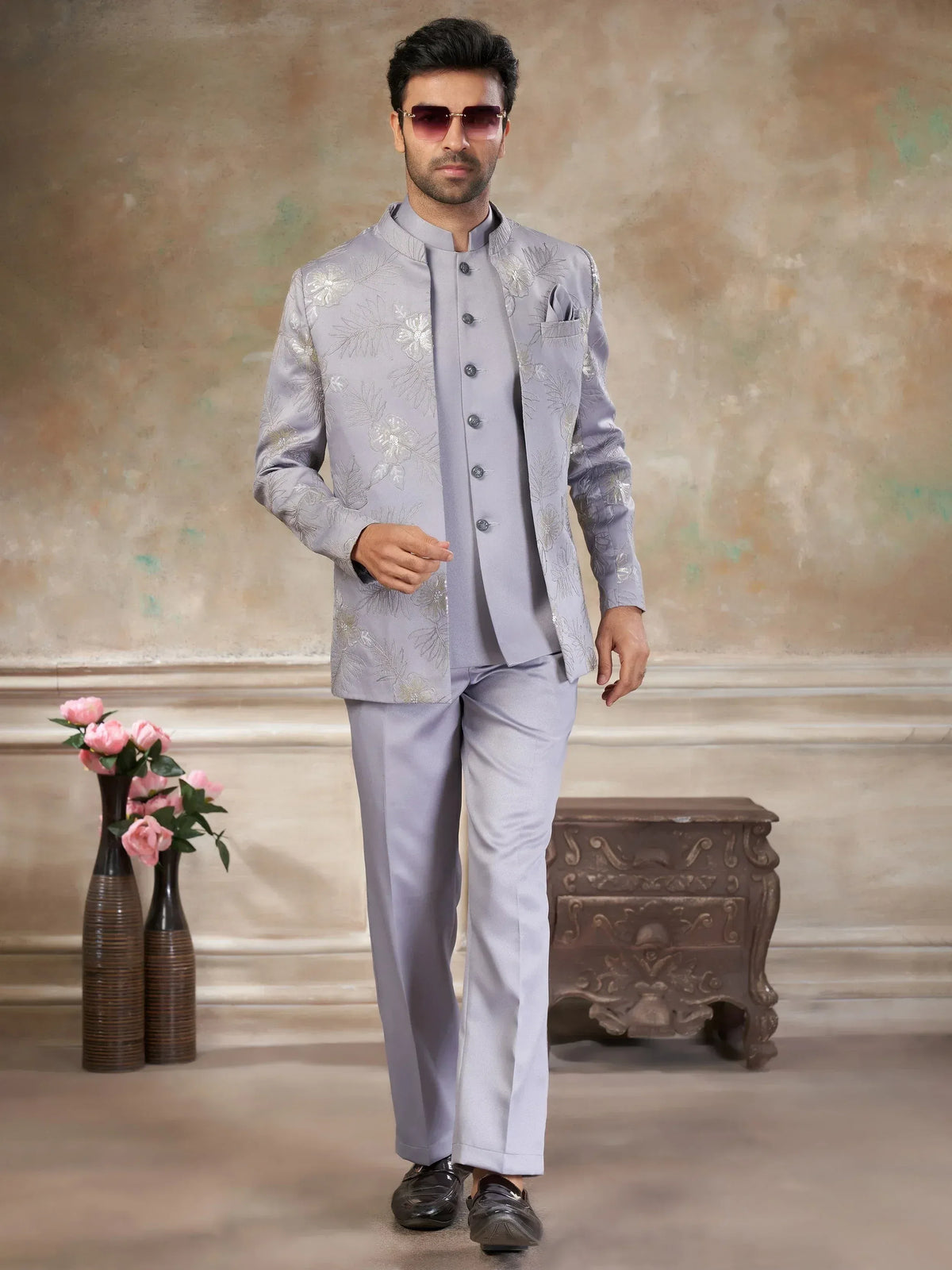 Man in light grey embroidered sherwani with matching pants, ideal for Indian weddings or festive occasions.