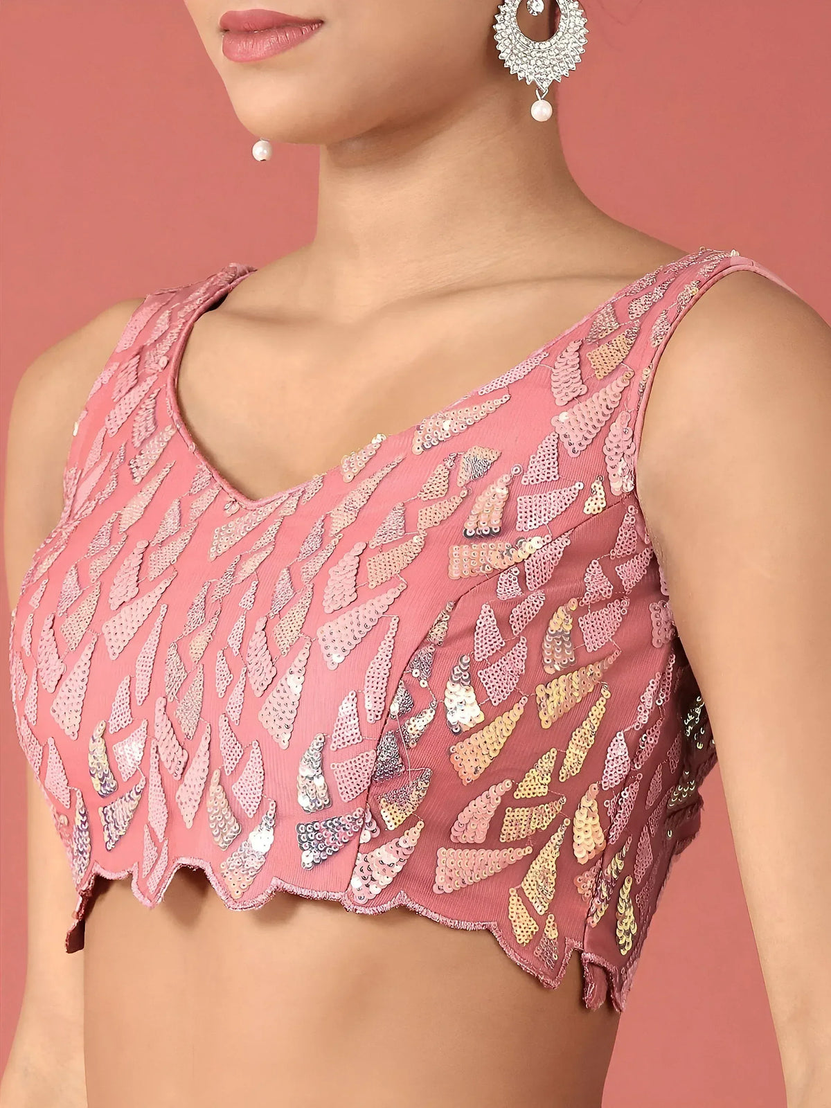 Pink sequin-embellished designer blouse with scalloped hem, perfect for ethnic wear and festive occasions.