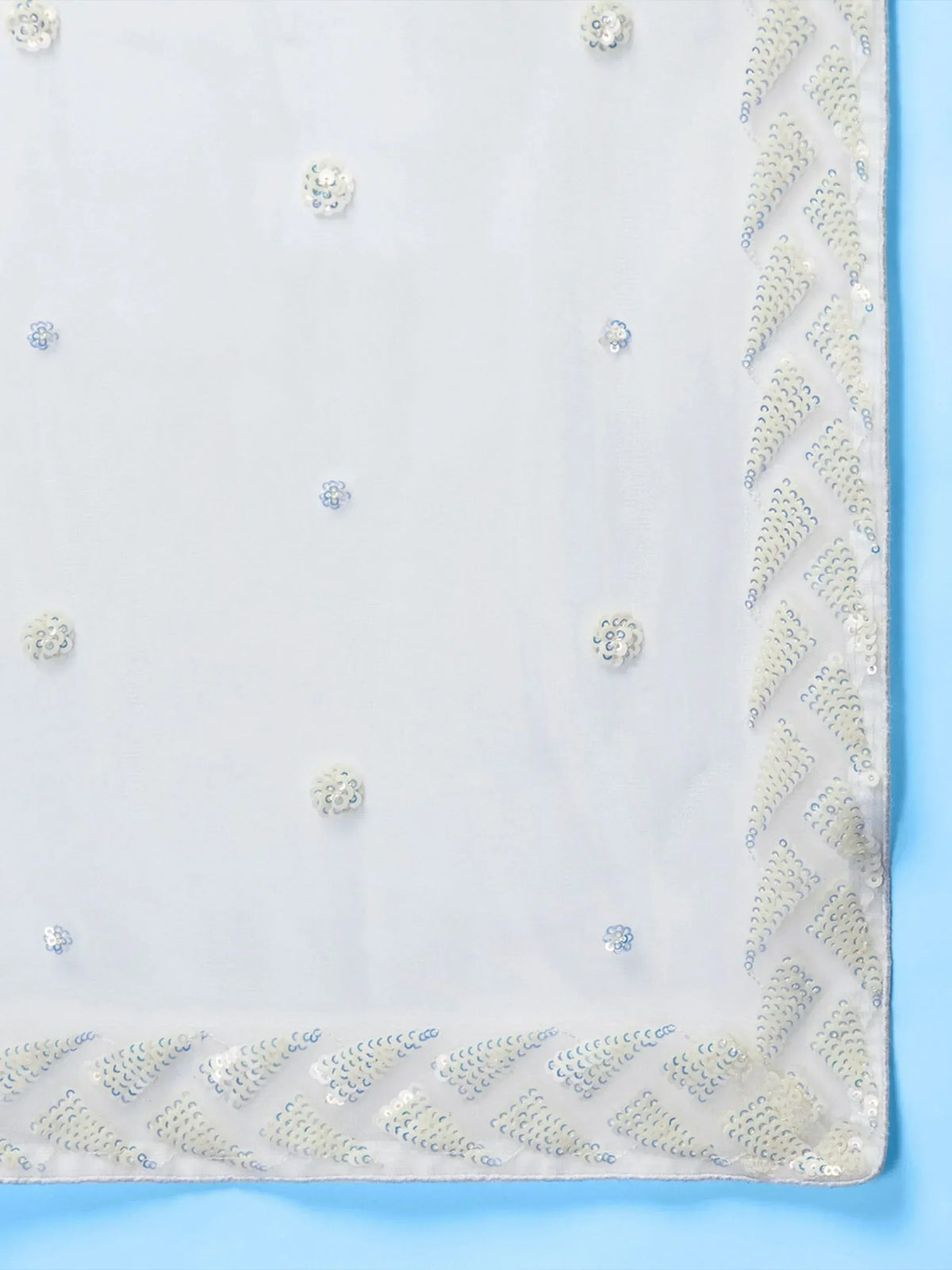 White sheer fabric with floral sequin embellishments and chevron border, ideal for ethnic wear designs.