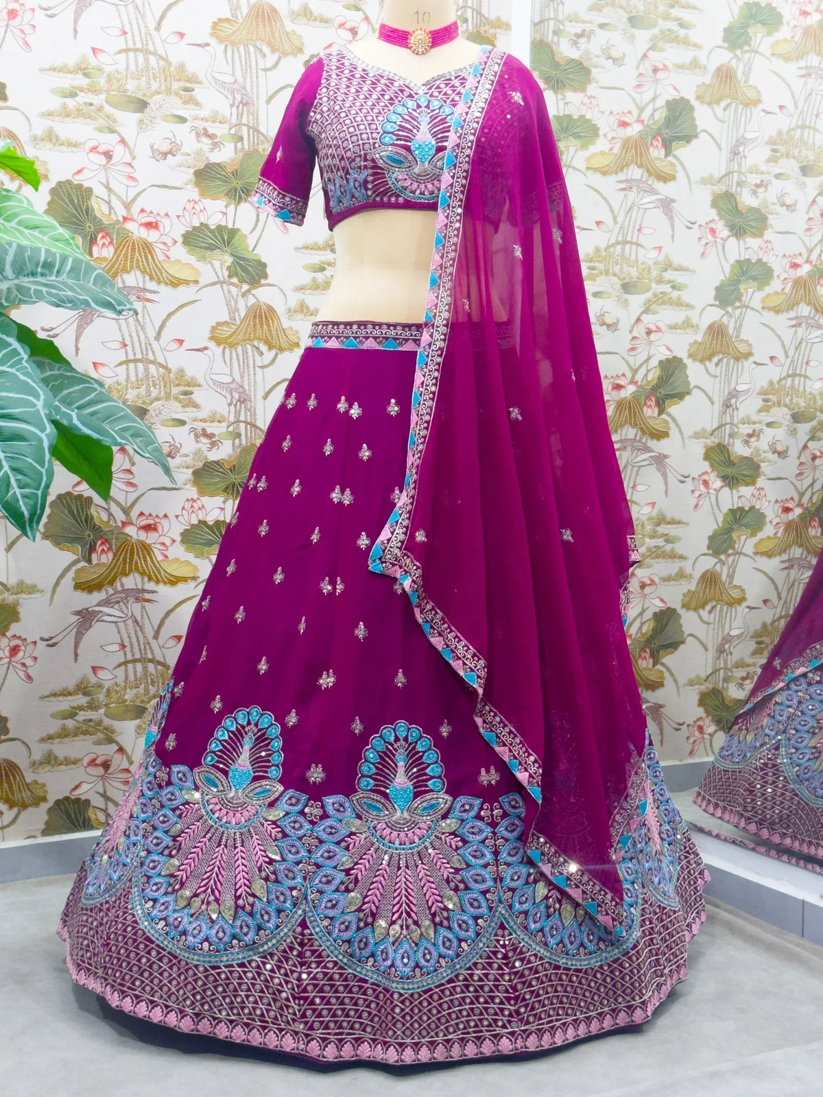 Magenta designer lehenga choli with intricate blue and silver embroidery