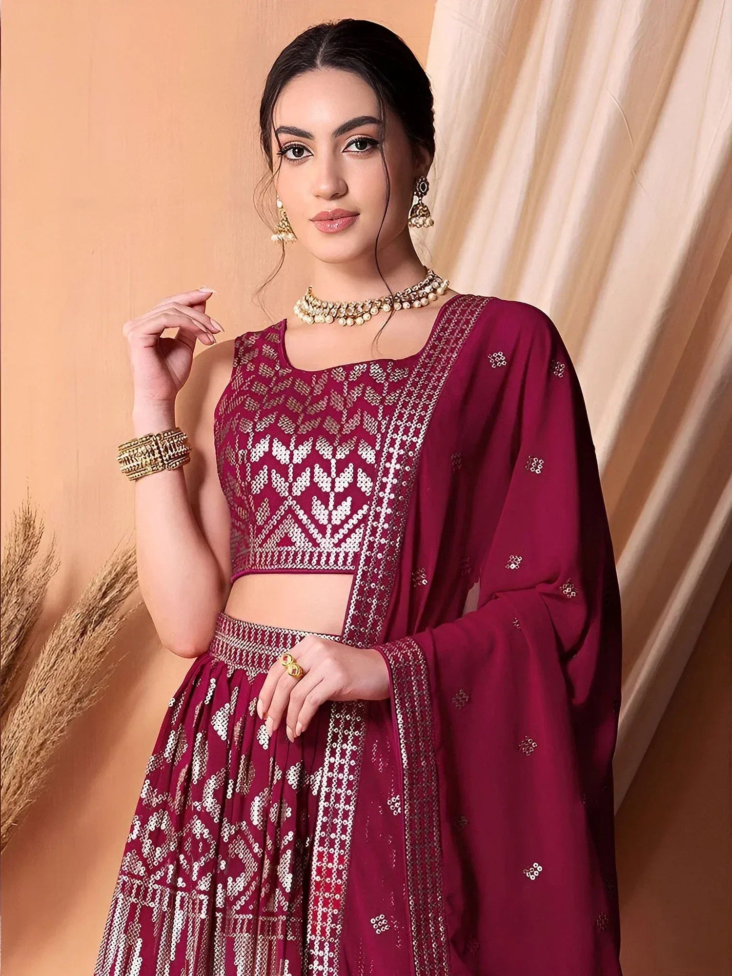 Maroon designer lehenga choli with intricate white embroidery and sequin work, perfect for Indian ethnic wear