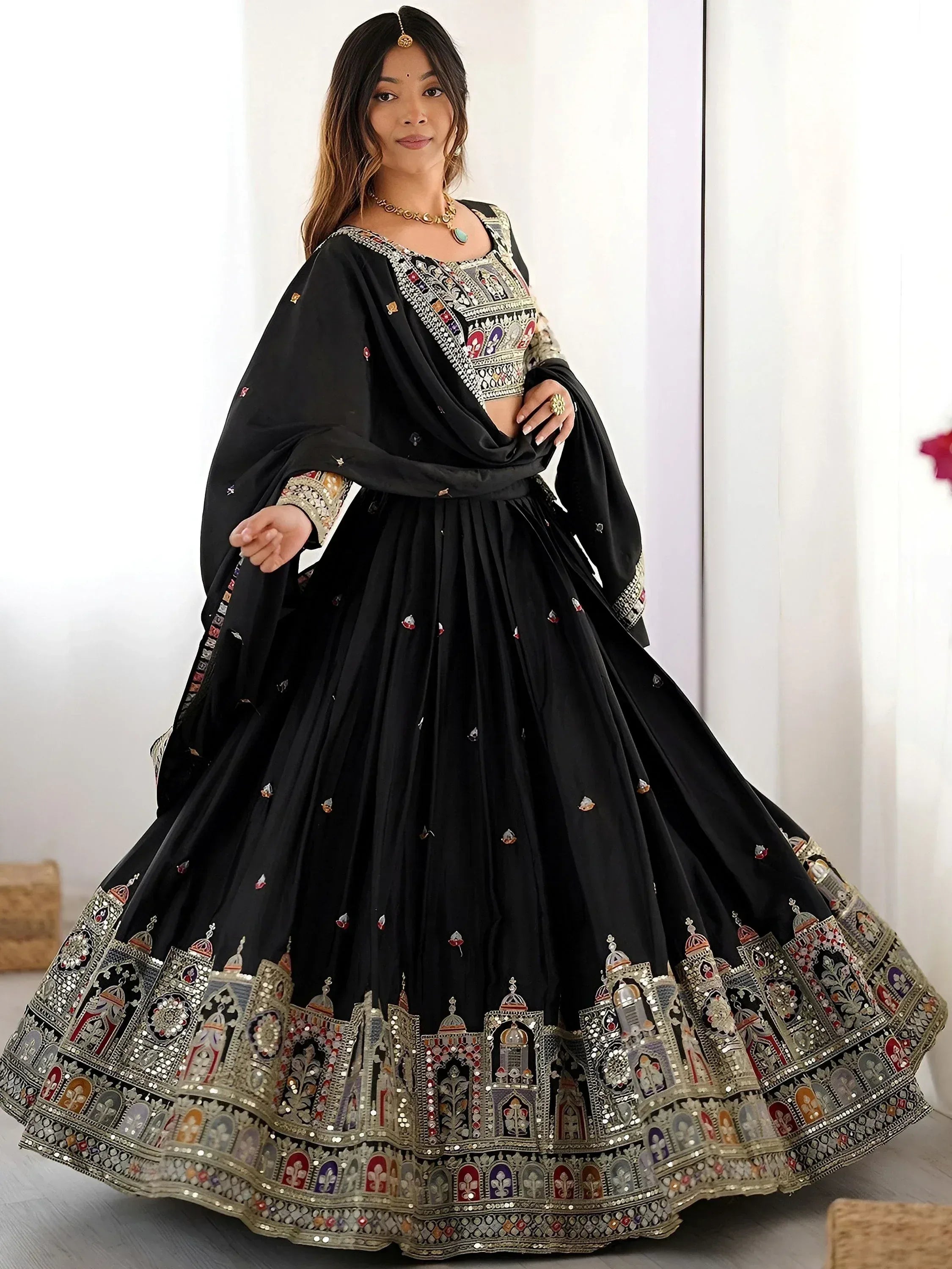 Black embroidered lehenga choli with intricate temple motifs and mirror work, perfect for Indian ethnic wear.